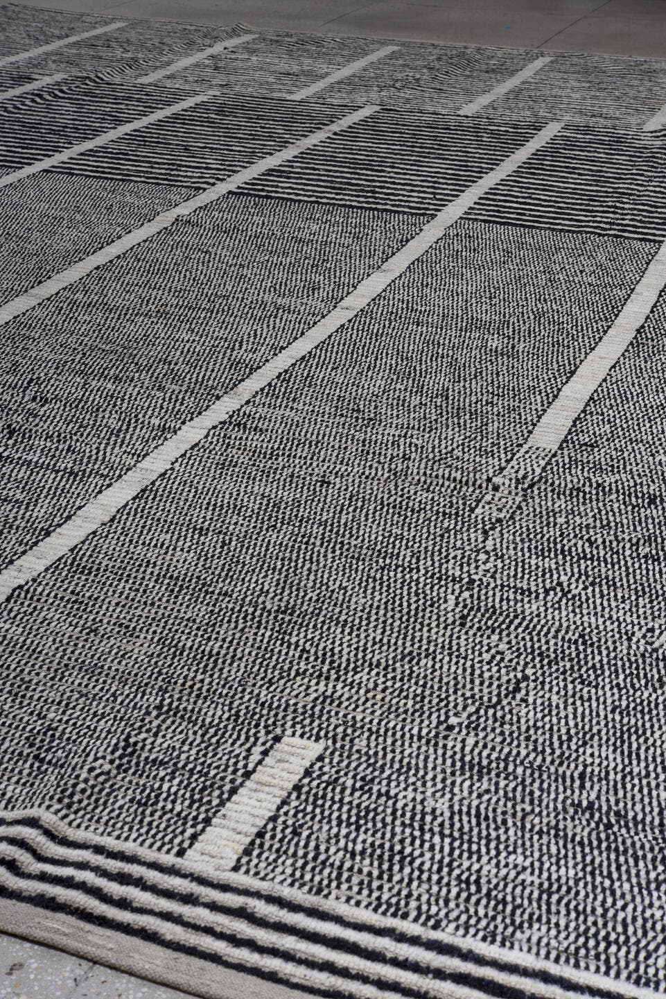 13' x 16' one-of-a-kind handmade vintage Tulu oversize rug. Color palette: ivory, charcoal, gray, black