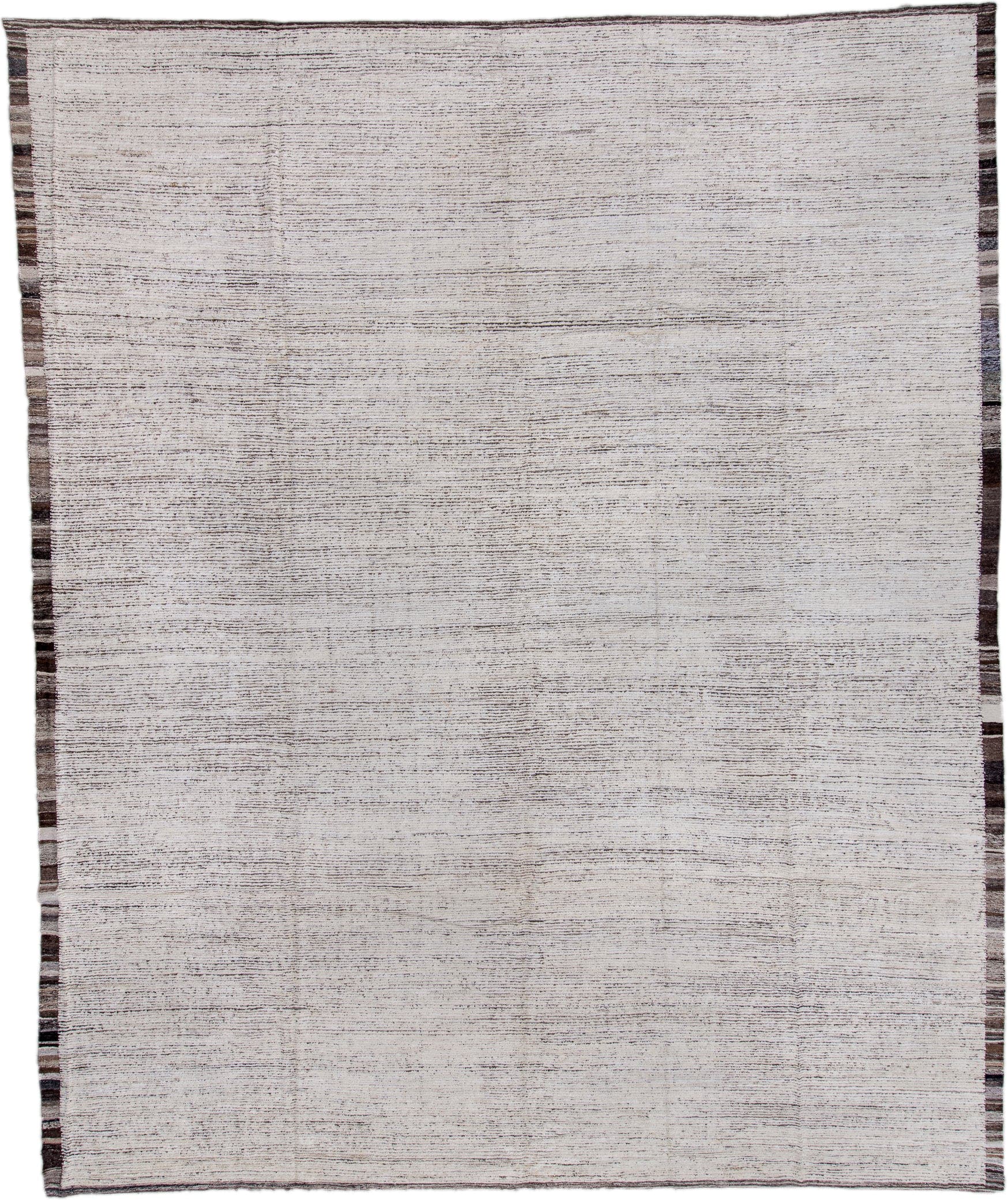 13' x 16' one-of-a-kind handmade vintage Tulu oversize rug. Color palette: ivory, charcoal, taupe, brown, gray, black, beige