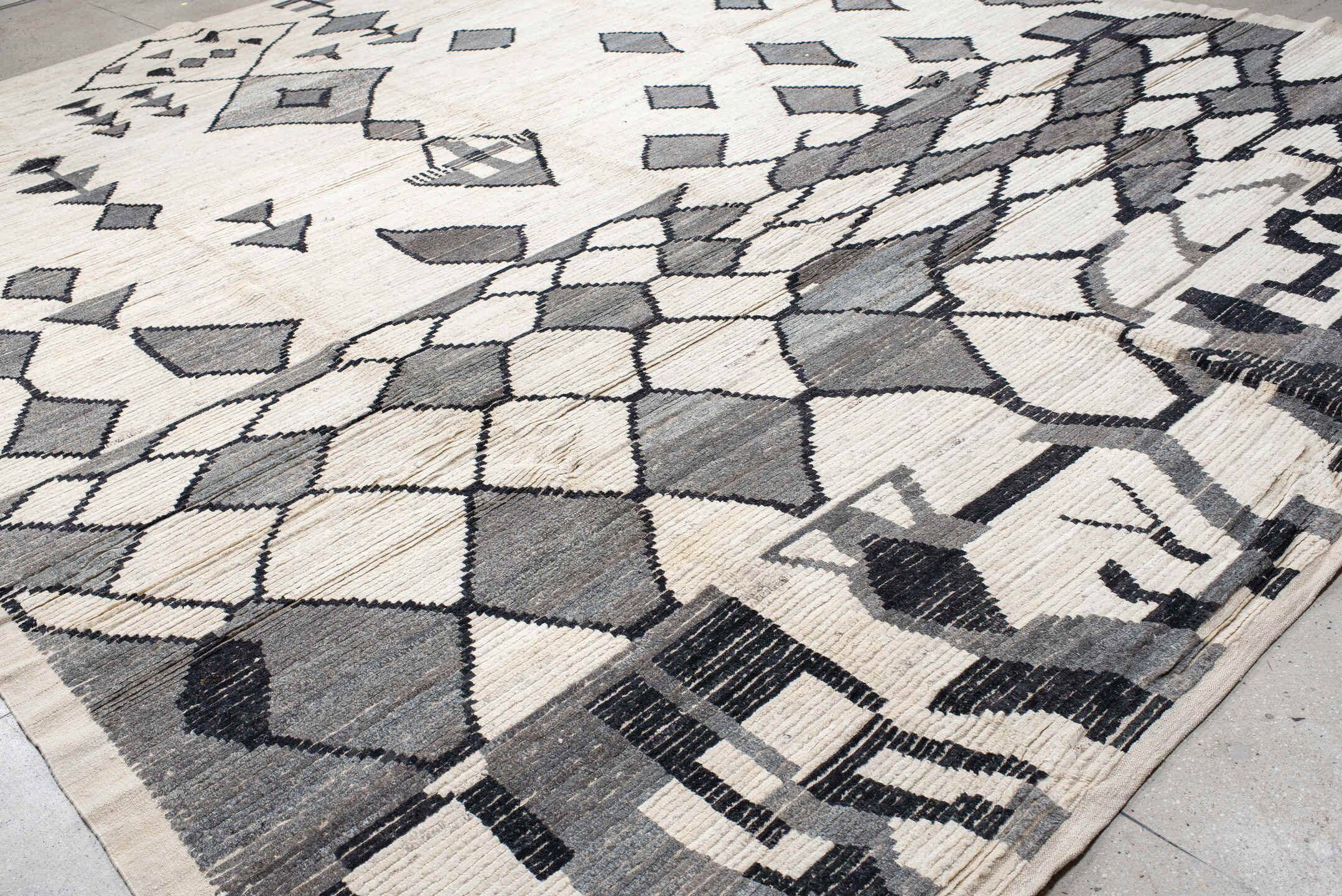 13' x 17' one-of-a-kind handmade vintage Tulu oversize rug. Color palette: ivory, charcoal, gray, black
