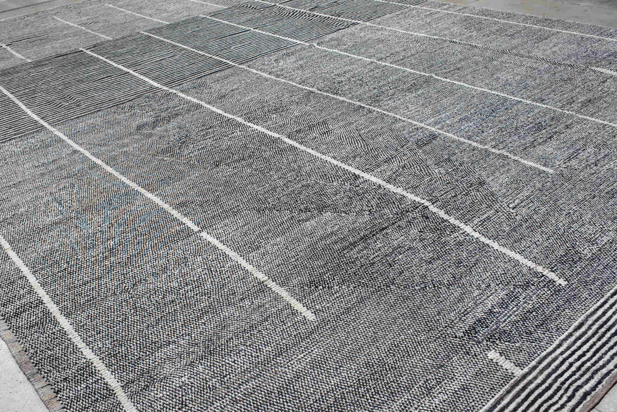 14' x 22' one-of-a-kind handmade vintage Tulu oversize rug. Color palette: charcoal, ivory, gray, black