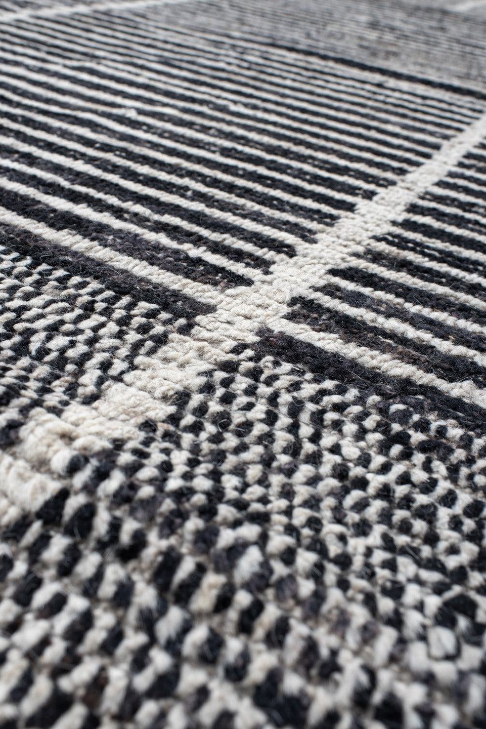 14' x 22' one-of-a-kind handmade vintage Tulu oversize rug. Color palette: charcoal, ivory, gray, black