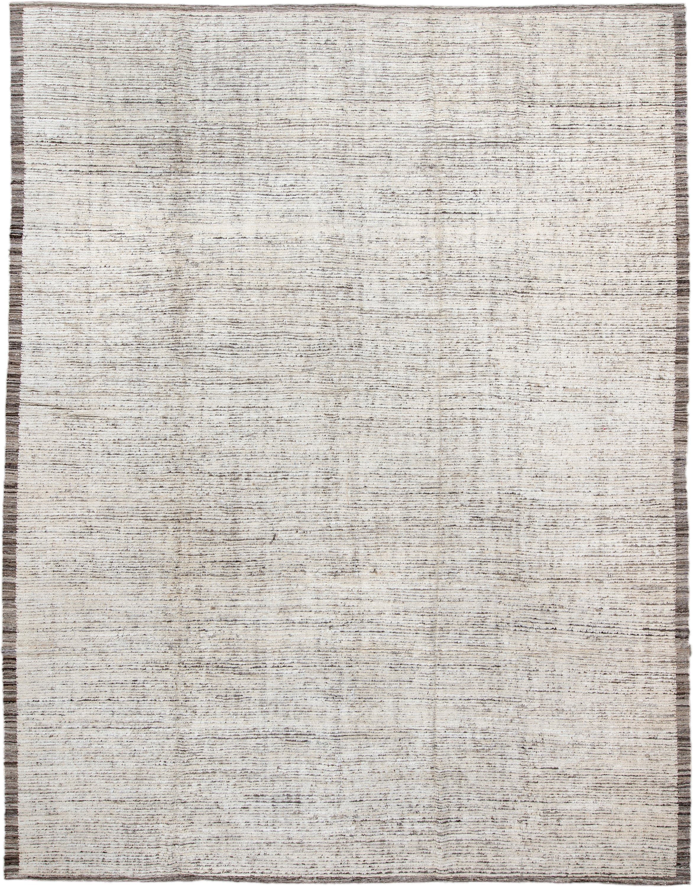 10' x 13' one-of-a-kind handmade vintage Tulu large size rug. Color palette: ivory, charcoal, taupe, brown, gray, black
