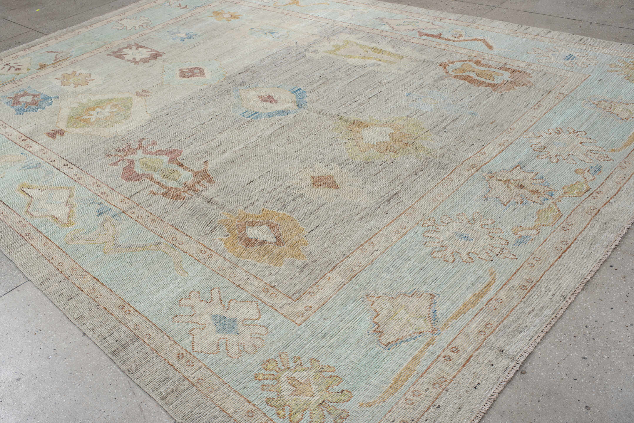 9' x 13' one-of-a-kind handmade vintage Oushak large size rug. Color palette: ivory, pale aqua, beige, sand, muted gold