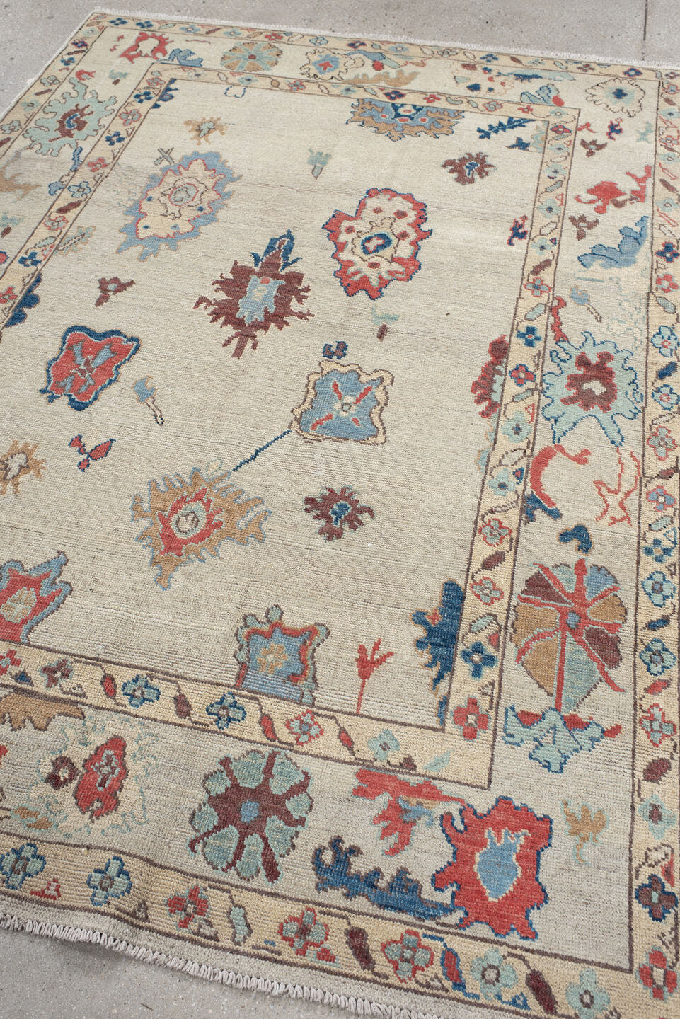 5' x 7' one-of-a-kind handmade vintage Oushak rug. Color palette: ivory, sky blue, rust, navy, taupe, brown, camel