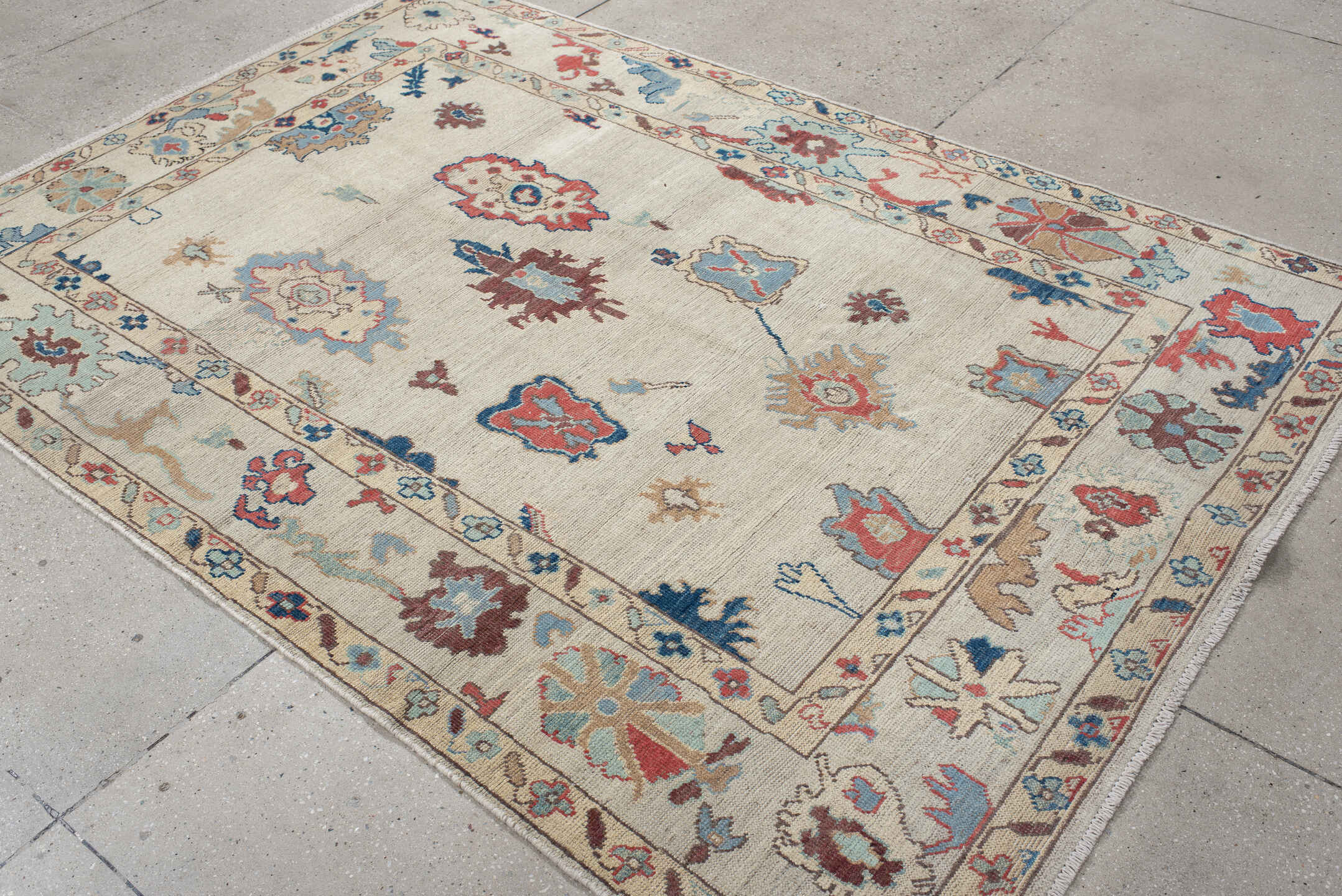 5' x 7' one-of-a-kind handmade vintage Oushak rug. Color palette: ivory, sky blue, rust, navy, taupe, brown, camel