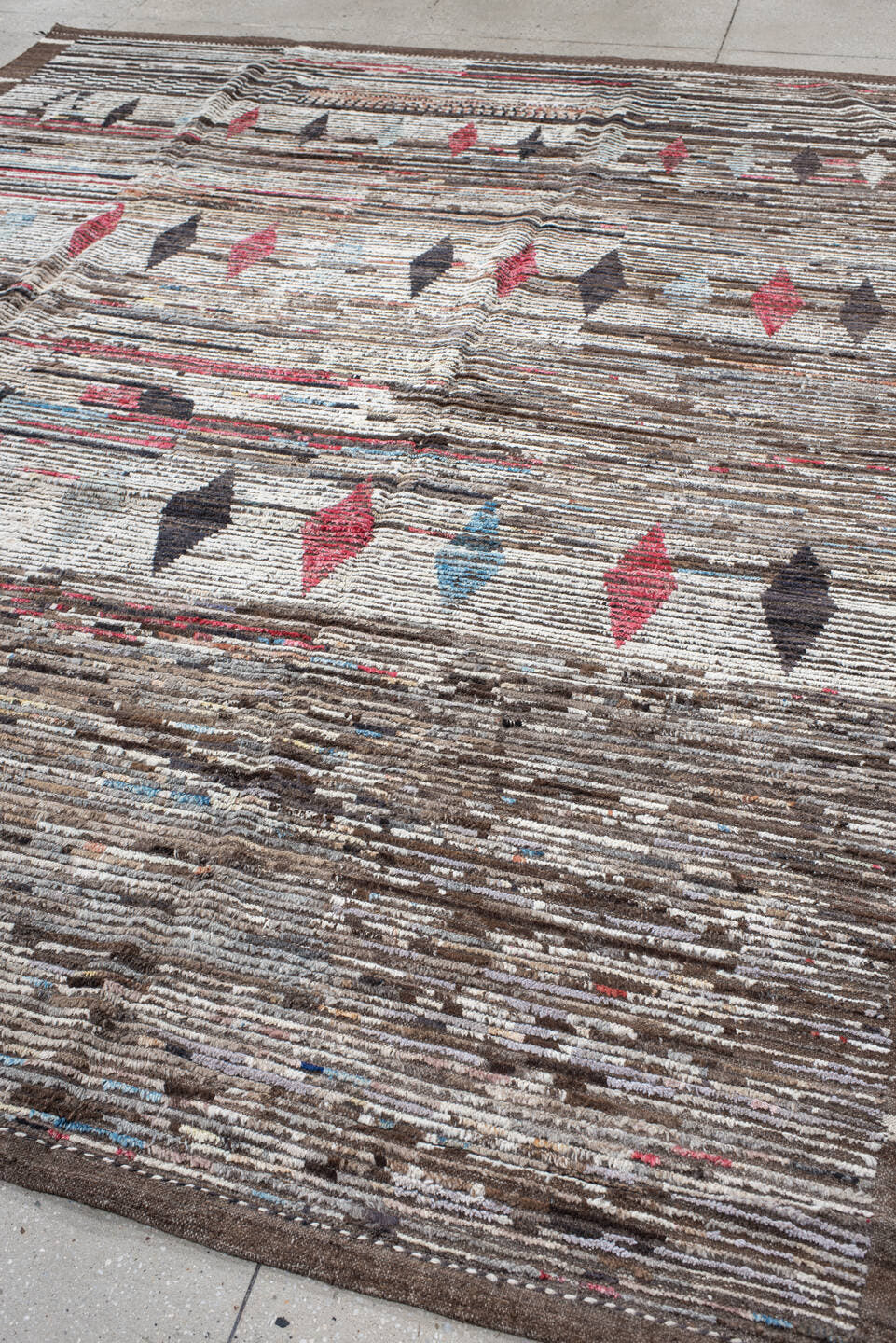 9' x 11' one-of-a-kind handmade vintage Tulu large size rug. Color palette: ivory, brown, charcoal, crimson, sky_blue, taupe