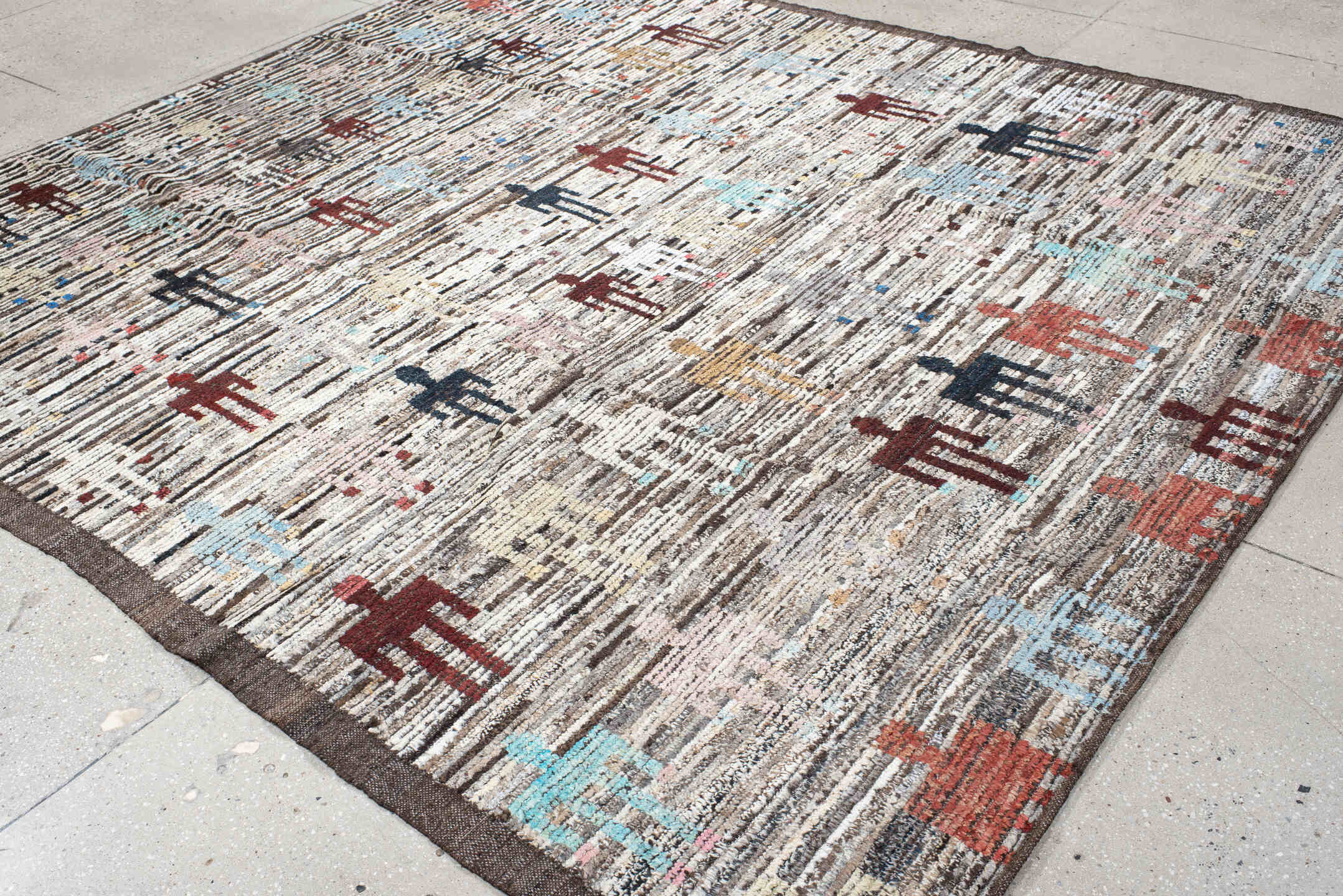 8' x 9' one-of-a-kind handmade vintage Tulu rug. Color palette: ivory, brown, taupe, rust, pale_blue, charcoal, burgundy