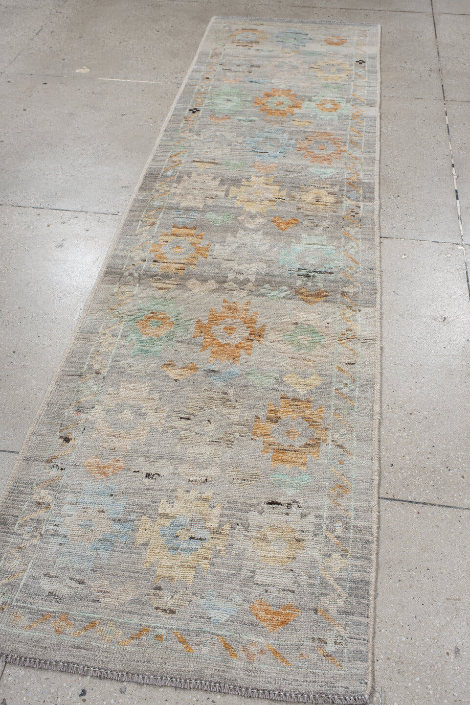 2' x 10' one-of-a-kind handmade vintage Tulu runner rug. Color palette: gray, ivory, aqua, apricot, taupe, charcoal, sand
