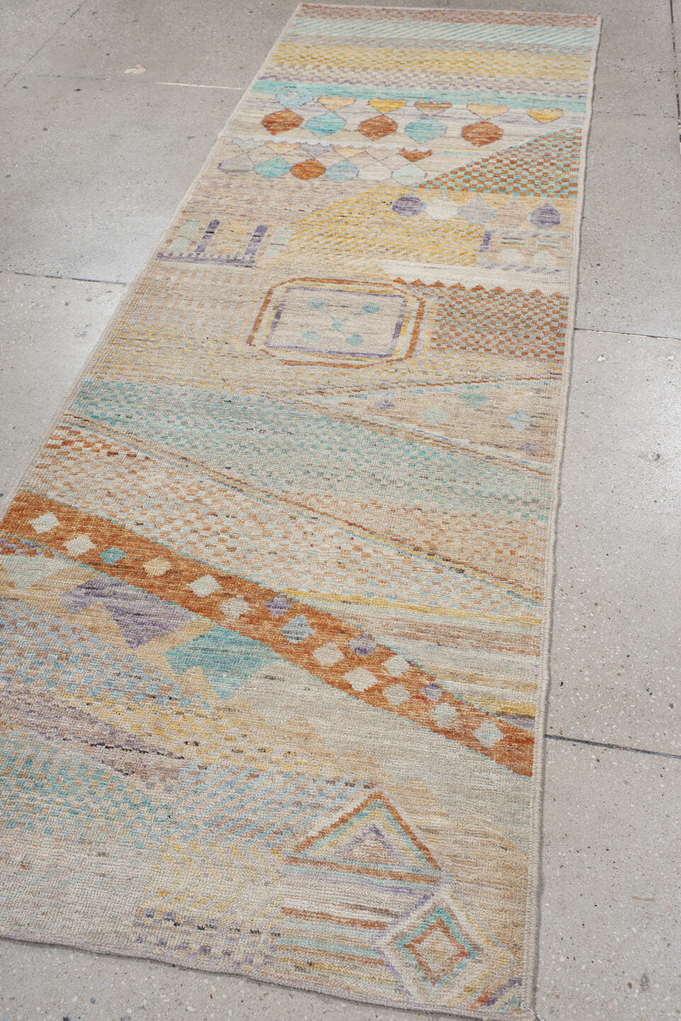 3' x 9' one-of-a-kind handmade vintage Tulu runner rug. Color palette: ivory, aqua, terra cotta, gold, lavender, taupe, teal
