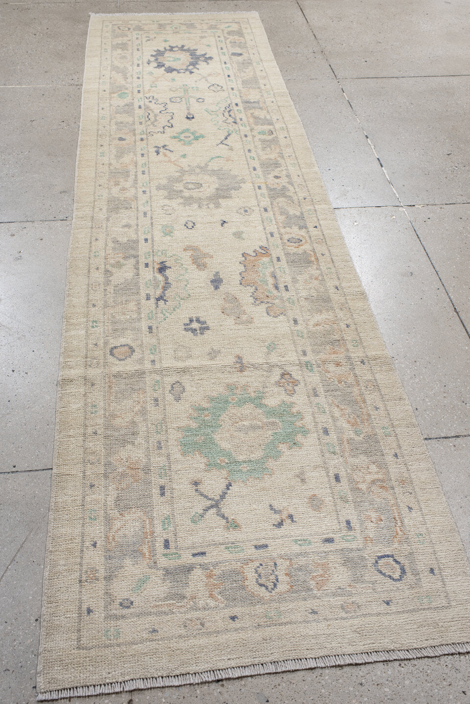 2' x 10' one-of-a-kind handmade vintage Oushak runner rug. Color palette: ivory, light gray, aqua, blue, beige, peach, teal