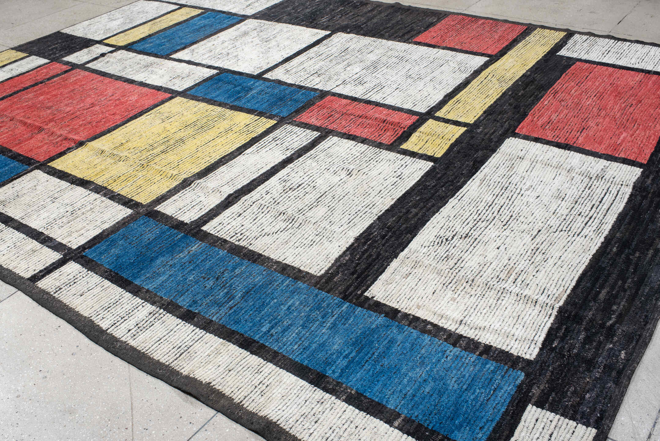 10' x 14' one-of-a-kind handmade vintage Tulu large size rug. Color palette: ivory, black, blue, red, yellow, gold