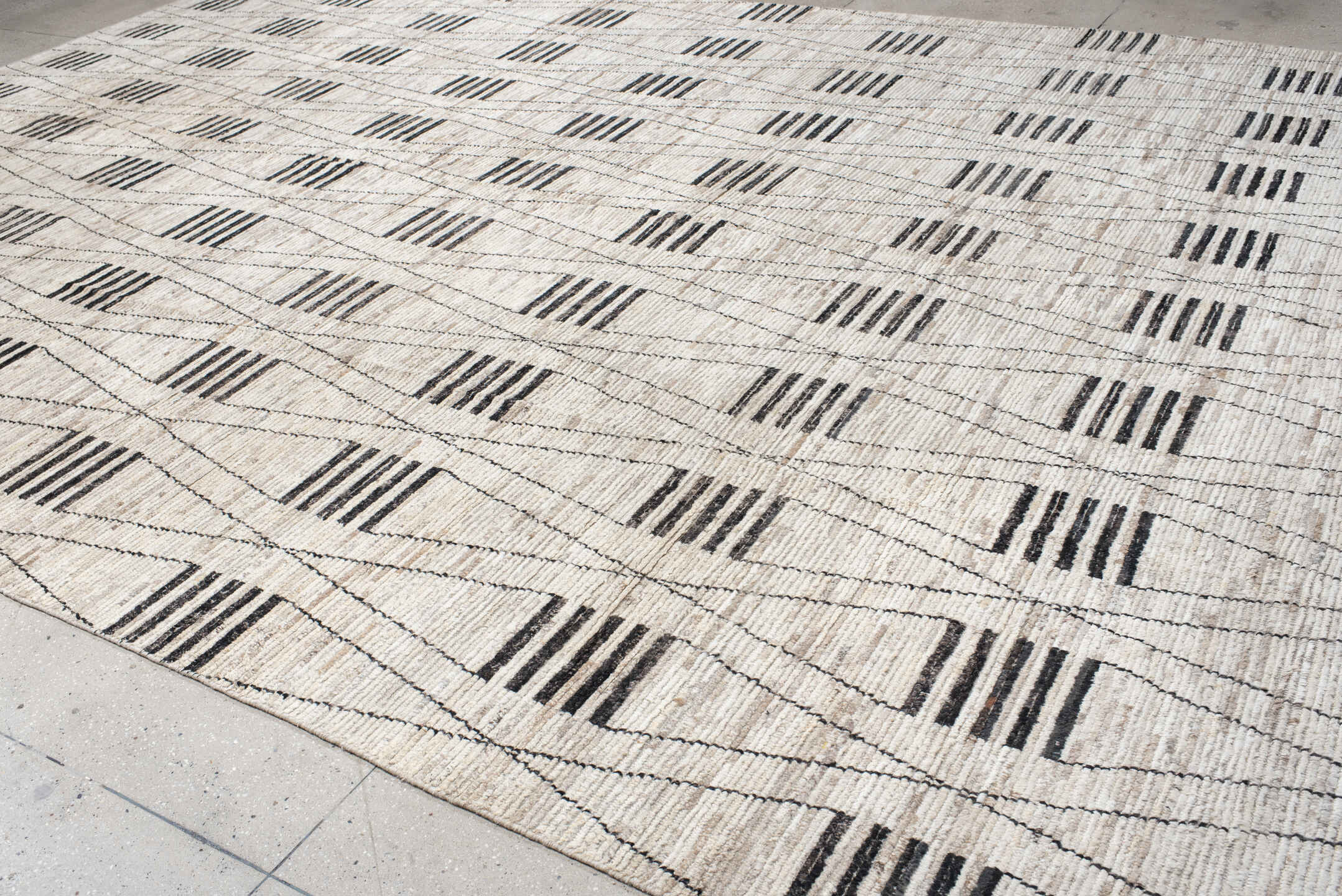 12' x 17' one-of-a-kind handmade vintage Tulu oversize rug. Color palette: ivory, charcoal, taupe, gray, black, beige