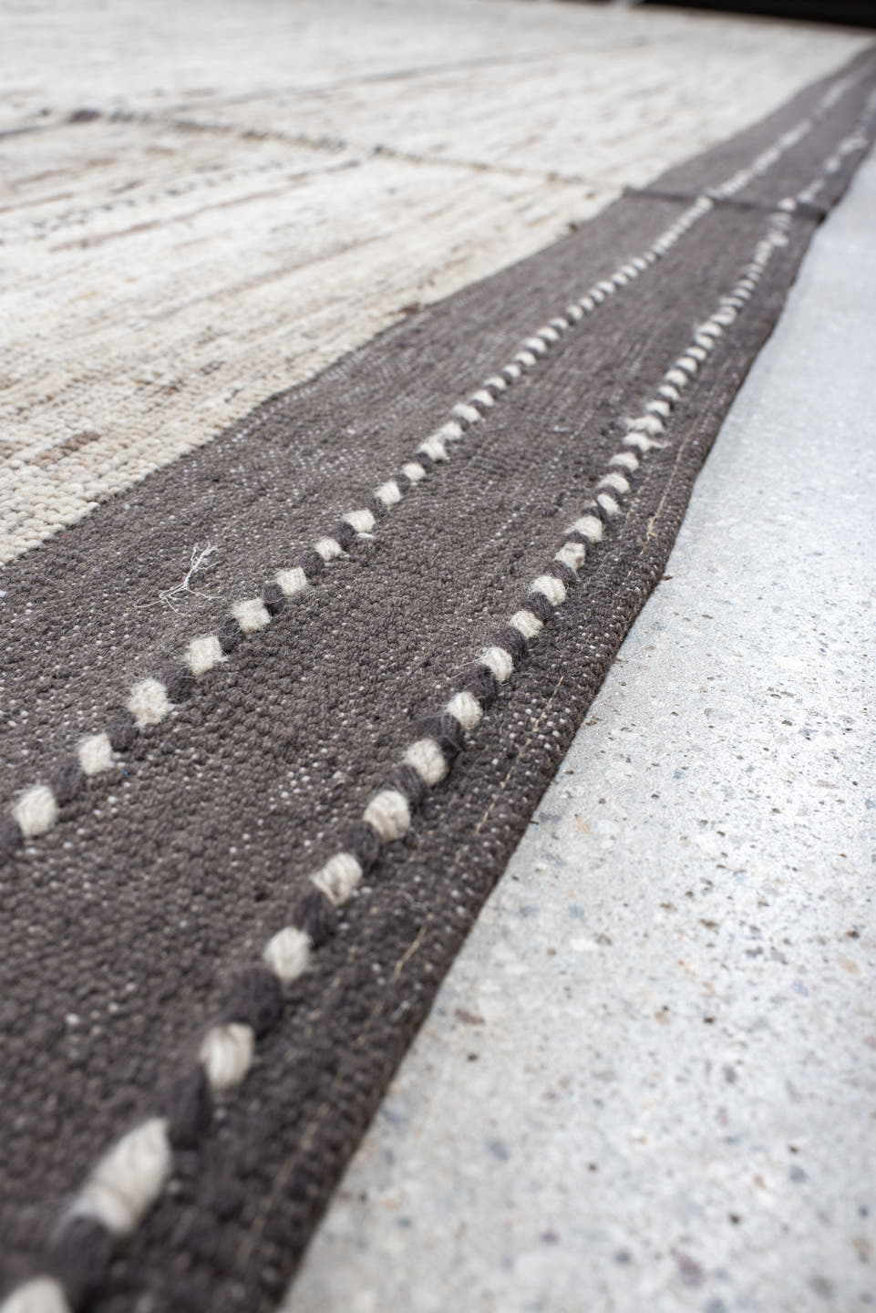 19' x 28' one-of-a-kind handmade vintage Tulu oversize rug. Color palette: ivory, charcoal, taupe, brown, gray, black, beige