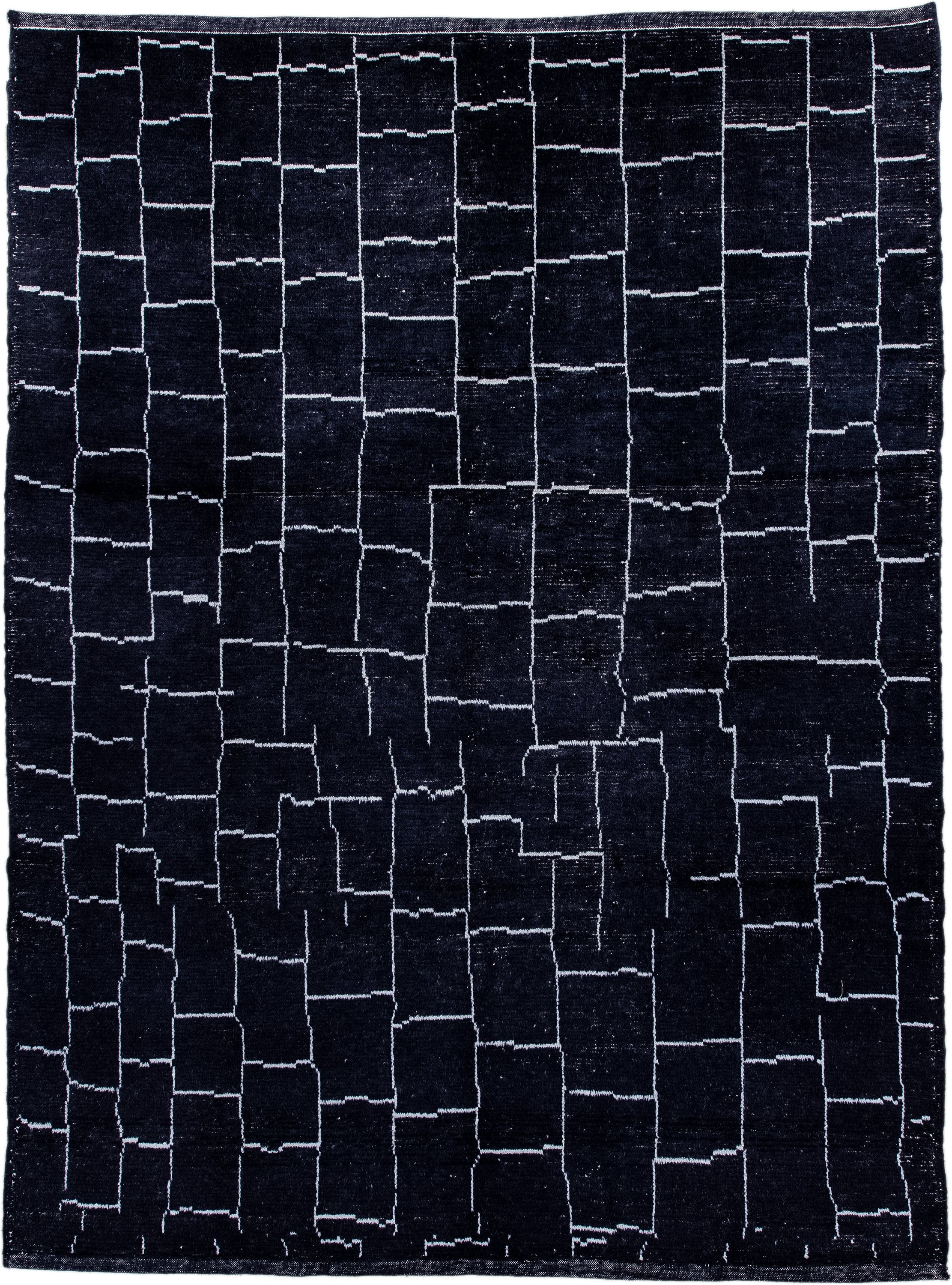 7' x 9' one-of-a-kind handmade vintage Moroccan rug. Color palette: black, ivory