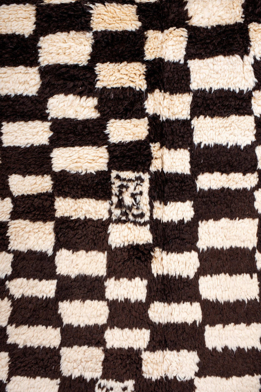 7' x 9' one-of-a-kind handmade vintage Moroccan rug. Color palette: ivory, brown, black, cream