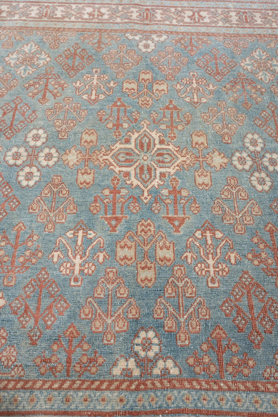 5' x 5' one-of-a-kind handmade antique Joshegan rug. Color palette: blue gray, ivory, coral, peach, sage, taupe, gray, blue