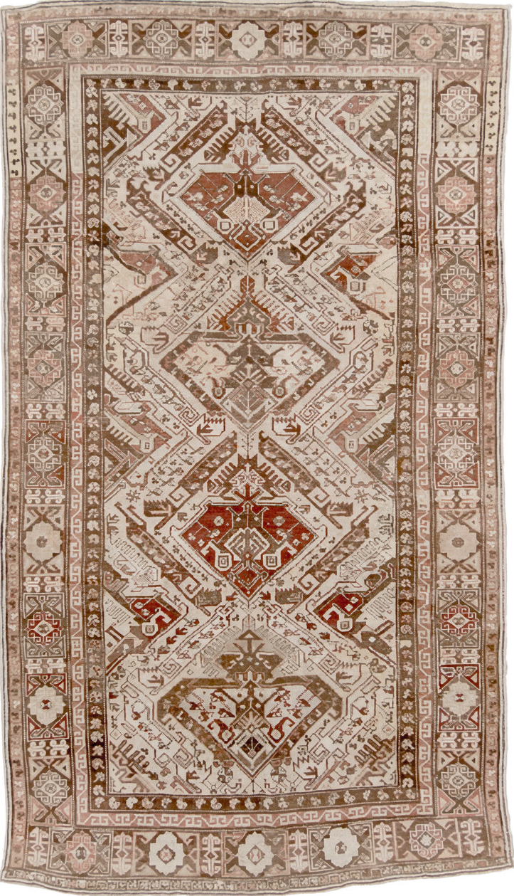 5' x 10' one-of-a-kind handmade vintage Caucasian medium size rug. Color palette: brown, gray, light gray, off-white, orange