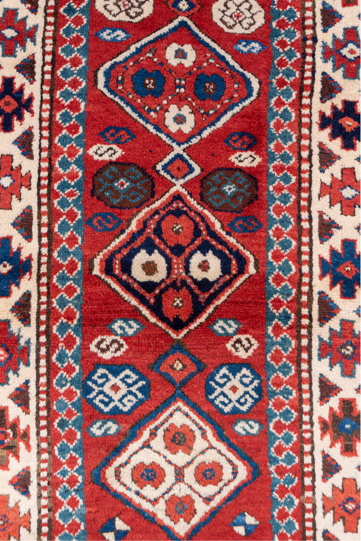 3' x 8' one-of-a-kind handmade vintage Kazak runner rug. Color palette: arapawa, blue, brown, fiord, gray, pink, red