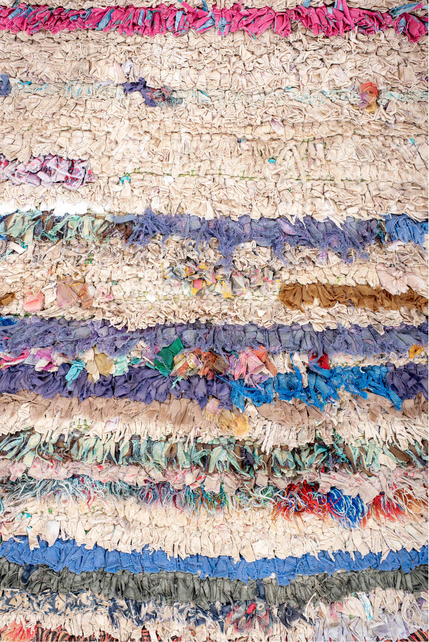 2' x 5' one-of-a-kind handmade vintage Rag Rug small size rug. Color palette: gray, blue, pink, brown, red, orange