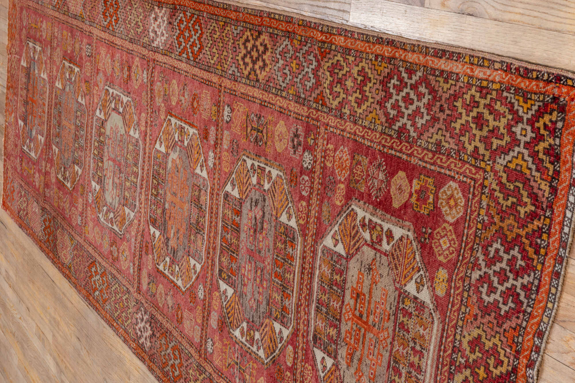 4' x 11' one-of-a-kind handmade vintage Oushak runner rug. Color palette: brown, maroon, pink, red, sienna