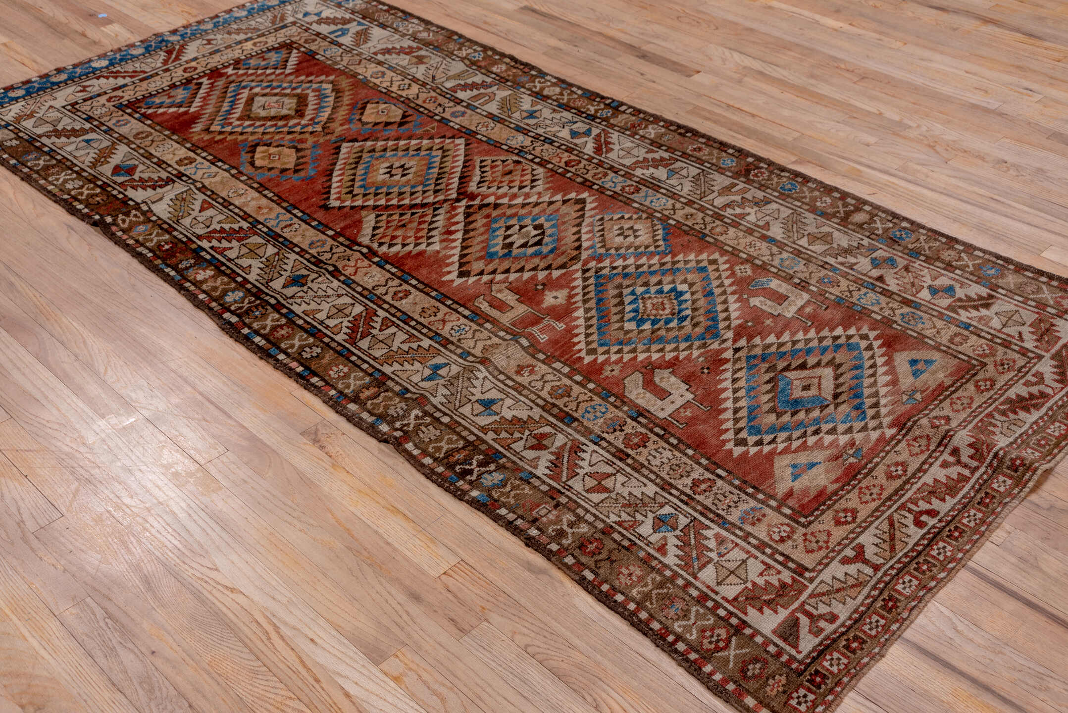 4' x 9' one-of-a-kind handmade vintage Kurd runner rug. Color palette: brown, gray, blue, pink, light gray, arapawa
