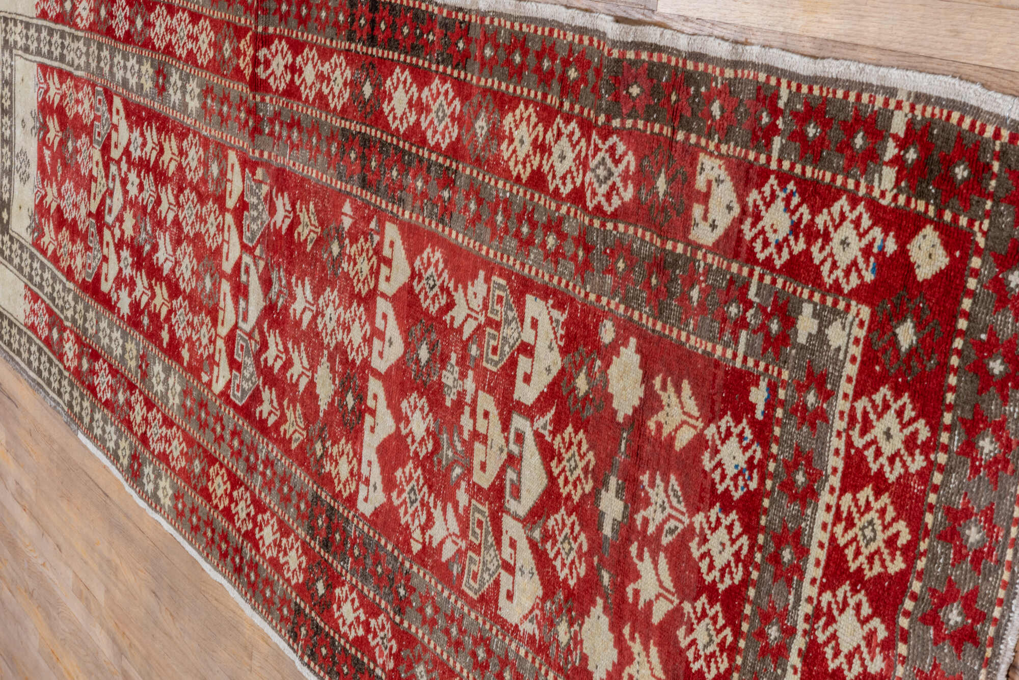 4' x 13' one-of-a-kind handmade vintage Caucasian runner rug. Color palette: brown, gray, pink, red