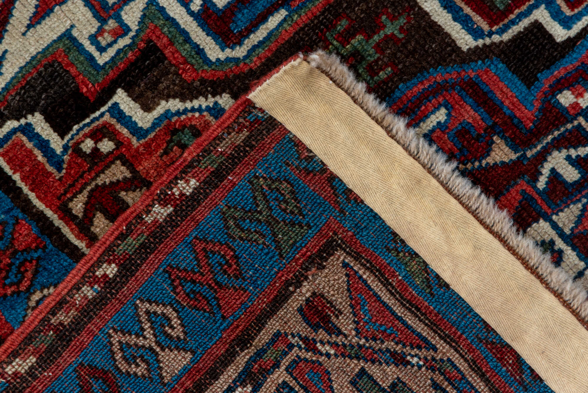 3' x 10' one-of-a-kind handmade vintage Kurd runner rug. Color palette: black, blue, brown, gray, pink, red