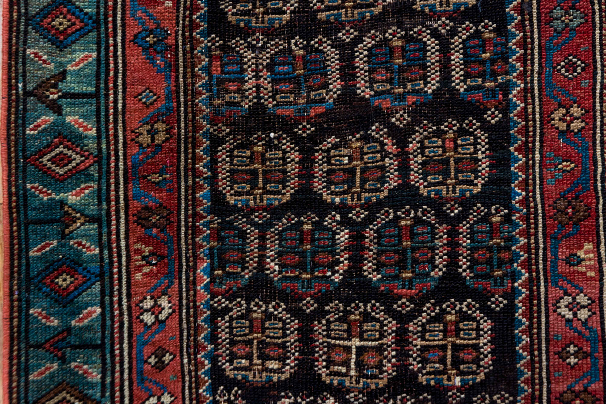 2' x 12' one-of-a-kind handmade vintage Caucasian runner rug. Color palette: black, brown, charcoal, gray, off-white, pink