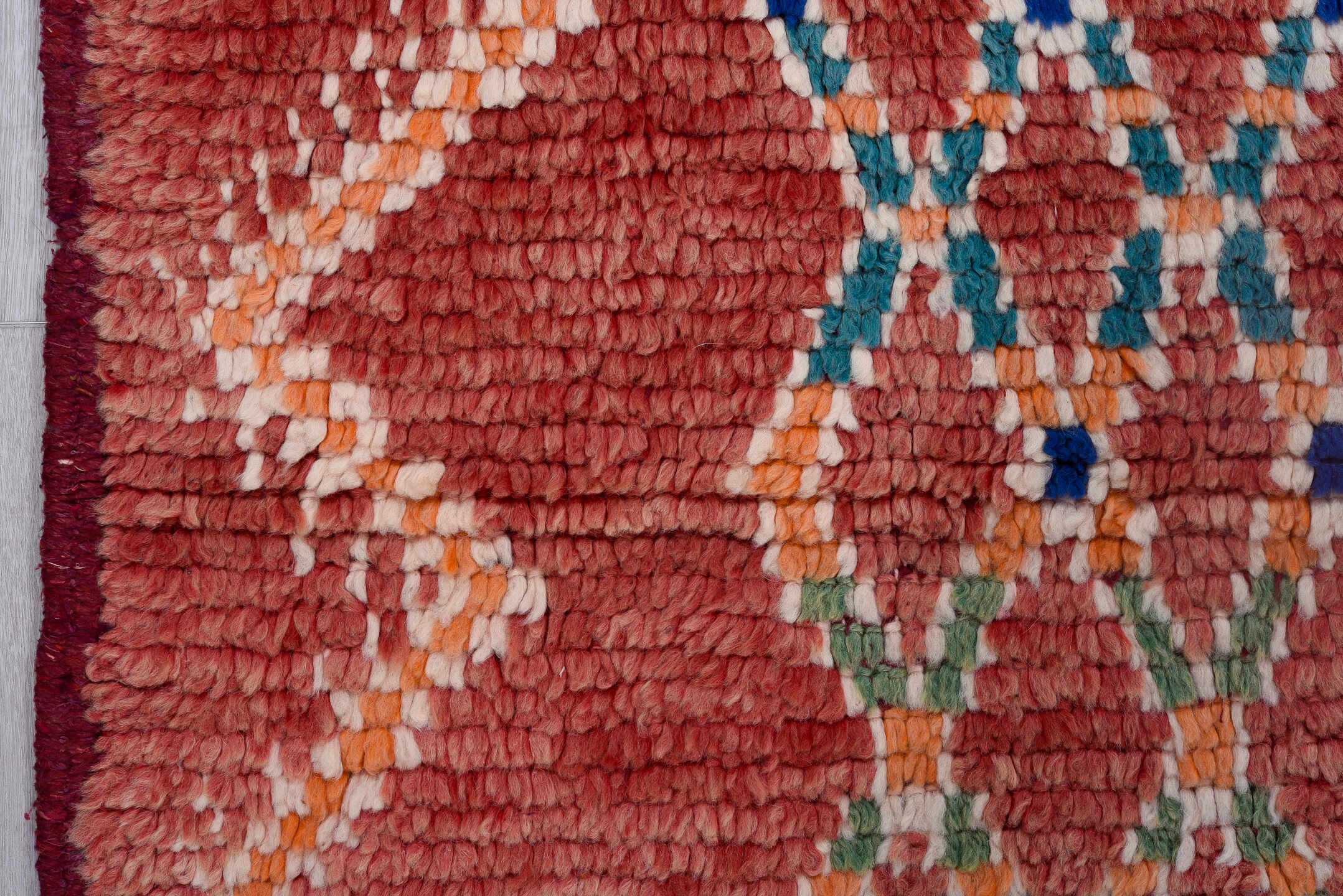 4' x 11' one-of-a-kind handmade vintage Moroccan runner rug. Color palette: pink, red, gray, light gray, brown, off-white