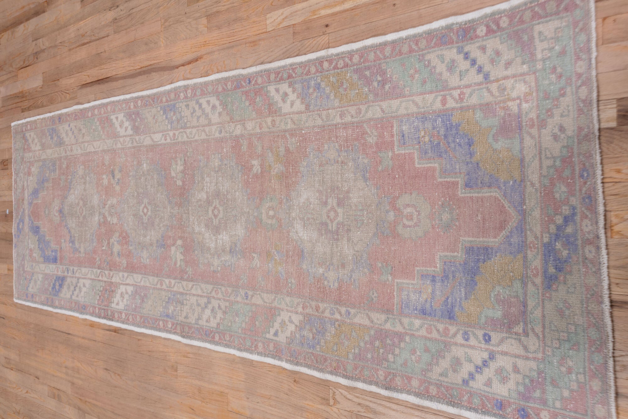 3' x 10' one-of-a-kind handmade vintage Oushak runner rug. Color palette: dark gray, gray, light gray, off-white, pink