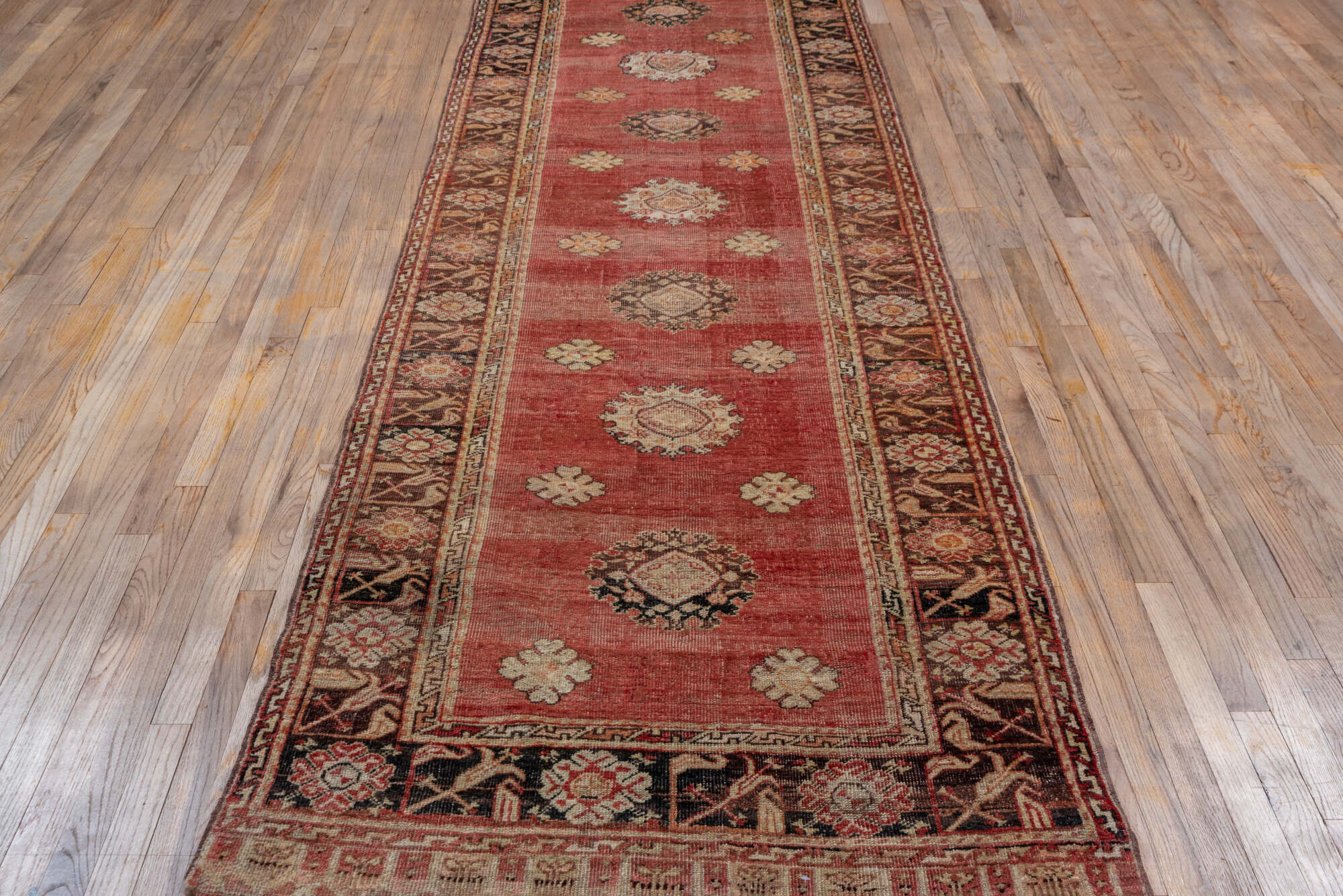 3' x 11' one-of-a-kind handmade vintage Oushak runner rug. Color palette: brown, orange, pink, red, redwood