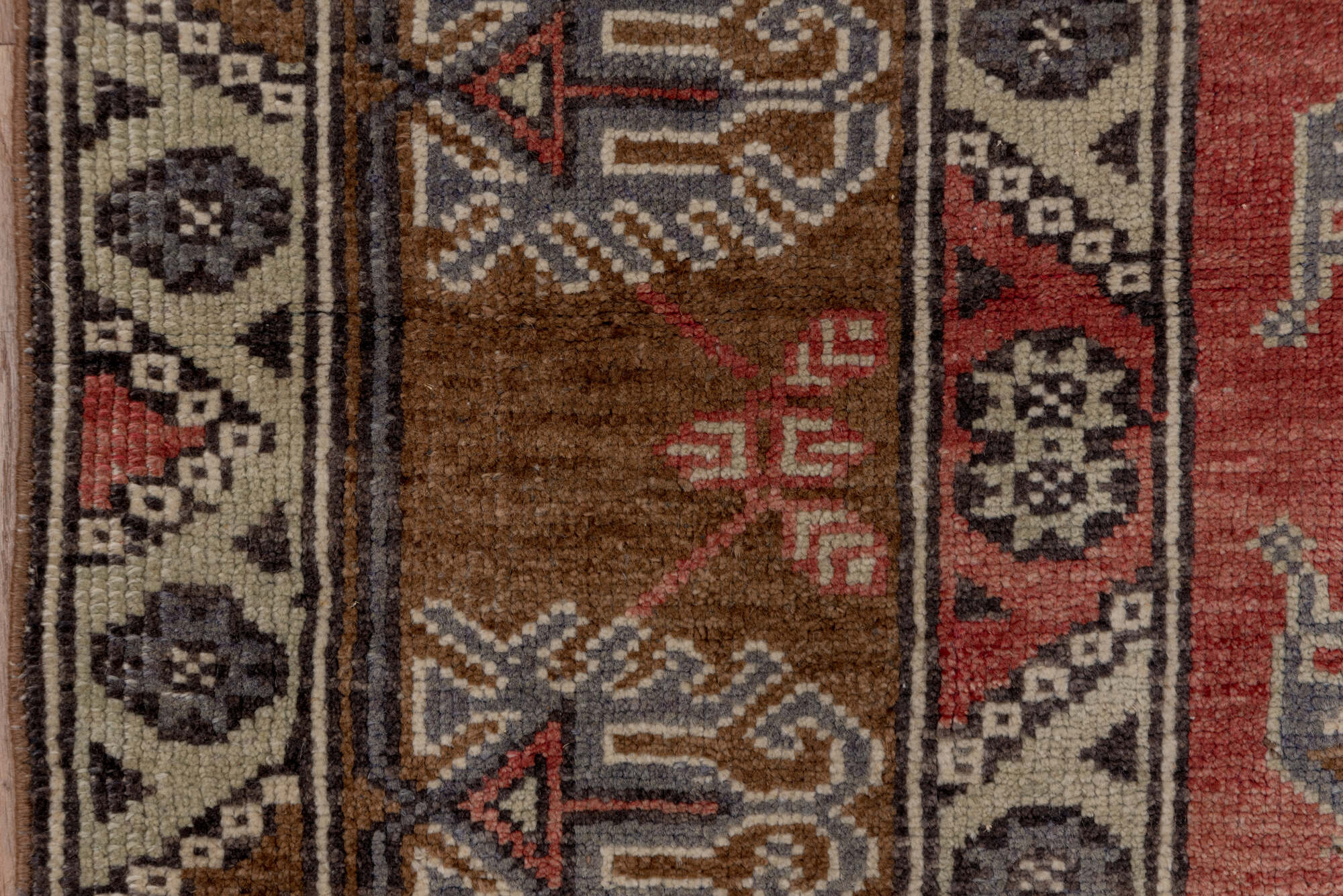 4' x 8' one-of-a-kind handmade vintage Konya runner rug. Color palette: brown, gray, pink, red