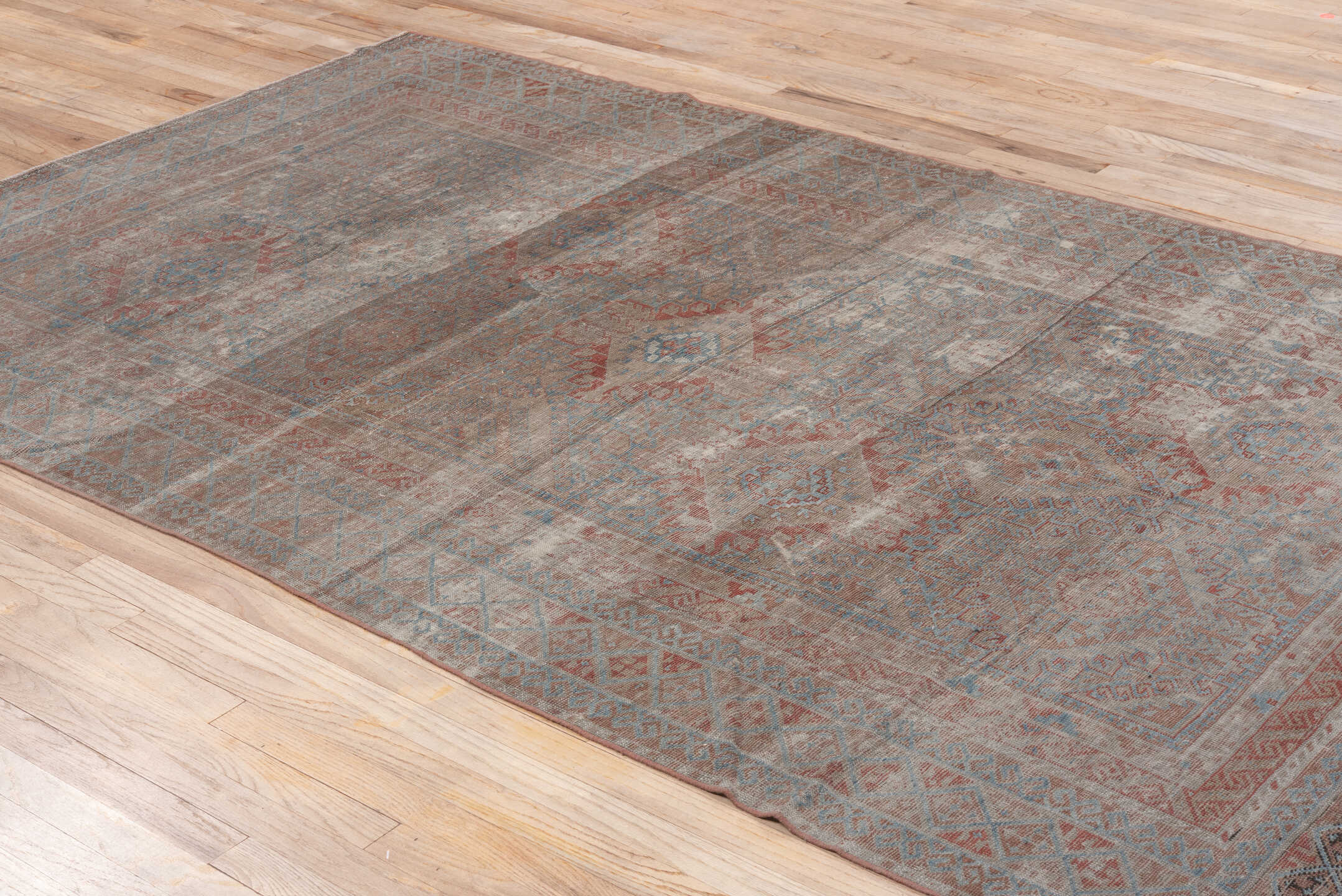 5' x 10' one-of-a-kind handmade vintage Belouch medium size rug. Color palette: gray, pink, light gray, brown, off-white