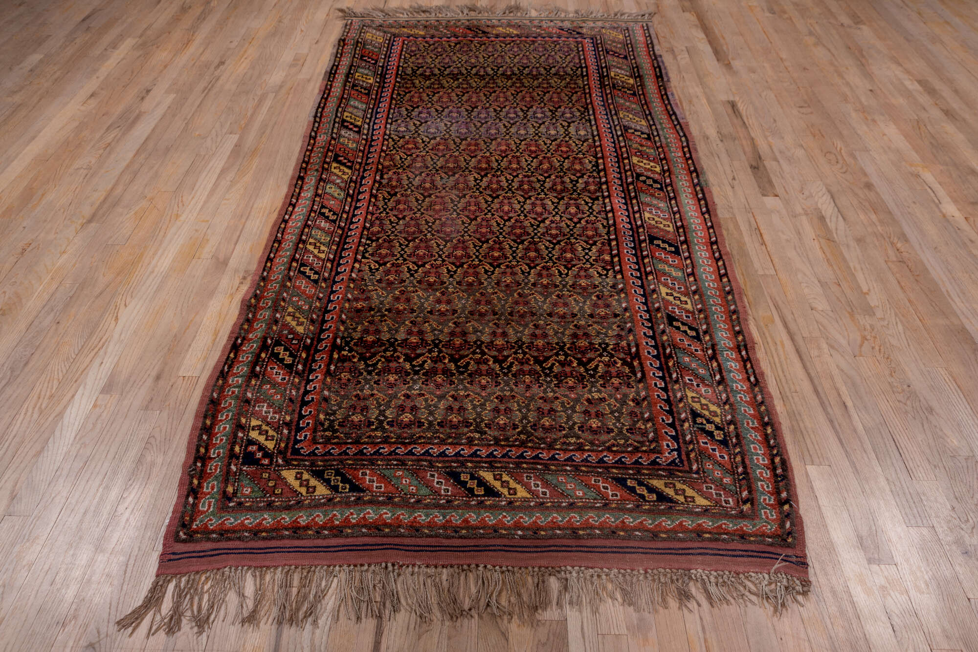 4' x 9' one-of-a-kind handmade vintage Kurd rug. Color palette: brown, dark gray, gray, light gray, off-white, pink, red