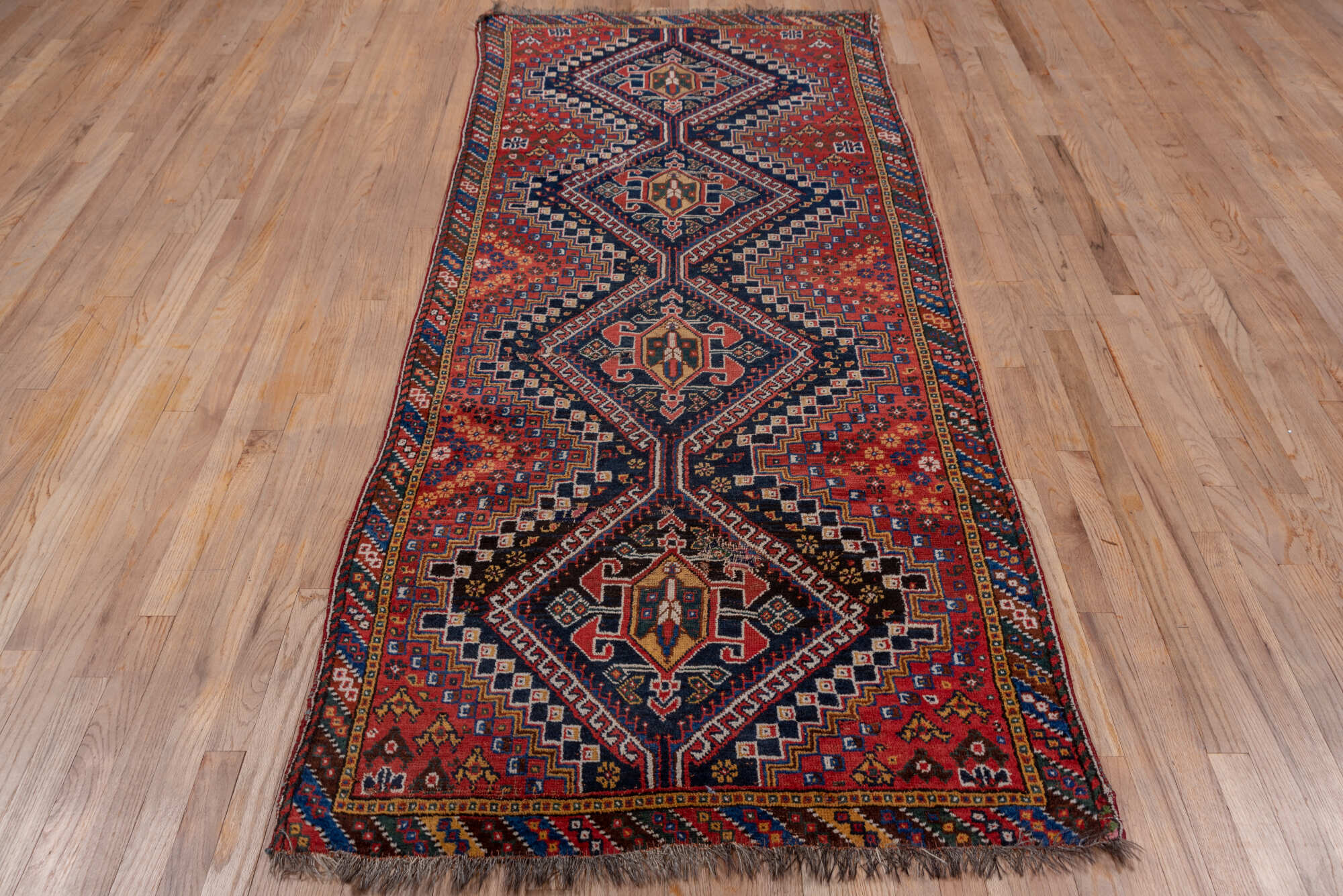 3' x 9' one-of-a-kind handmade vintage Shiraz runner rug. Color palette: black, blue, brown, fiord, gray, pink, red