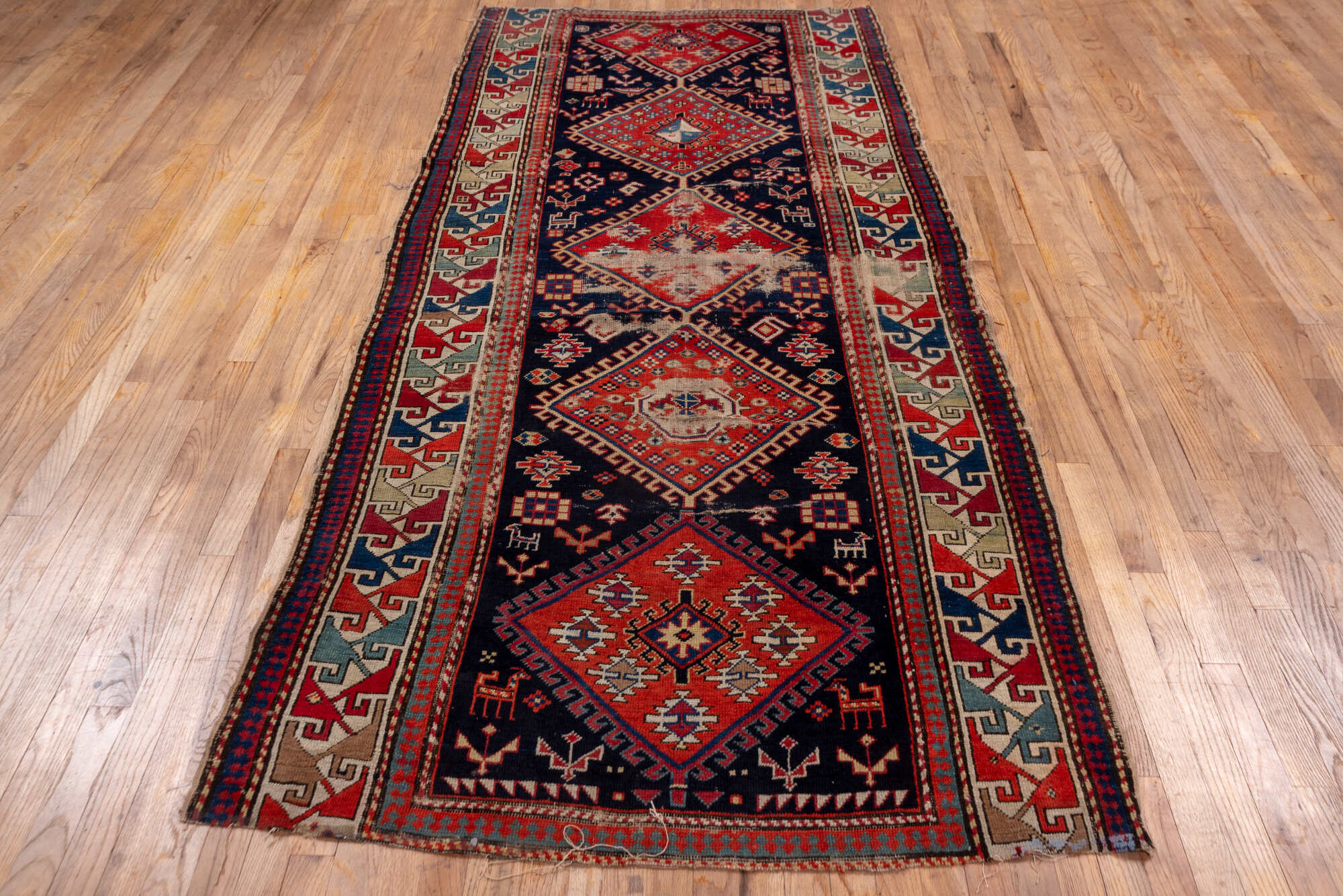 4' x 9' one-of-a-kind handmade vintage Shirvan runner rug. Color palette: blue, brown, gray, pink, red, redwood