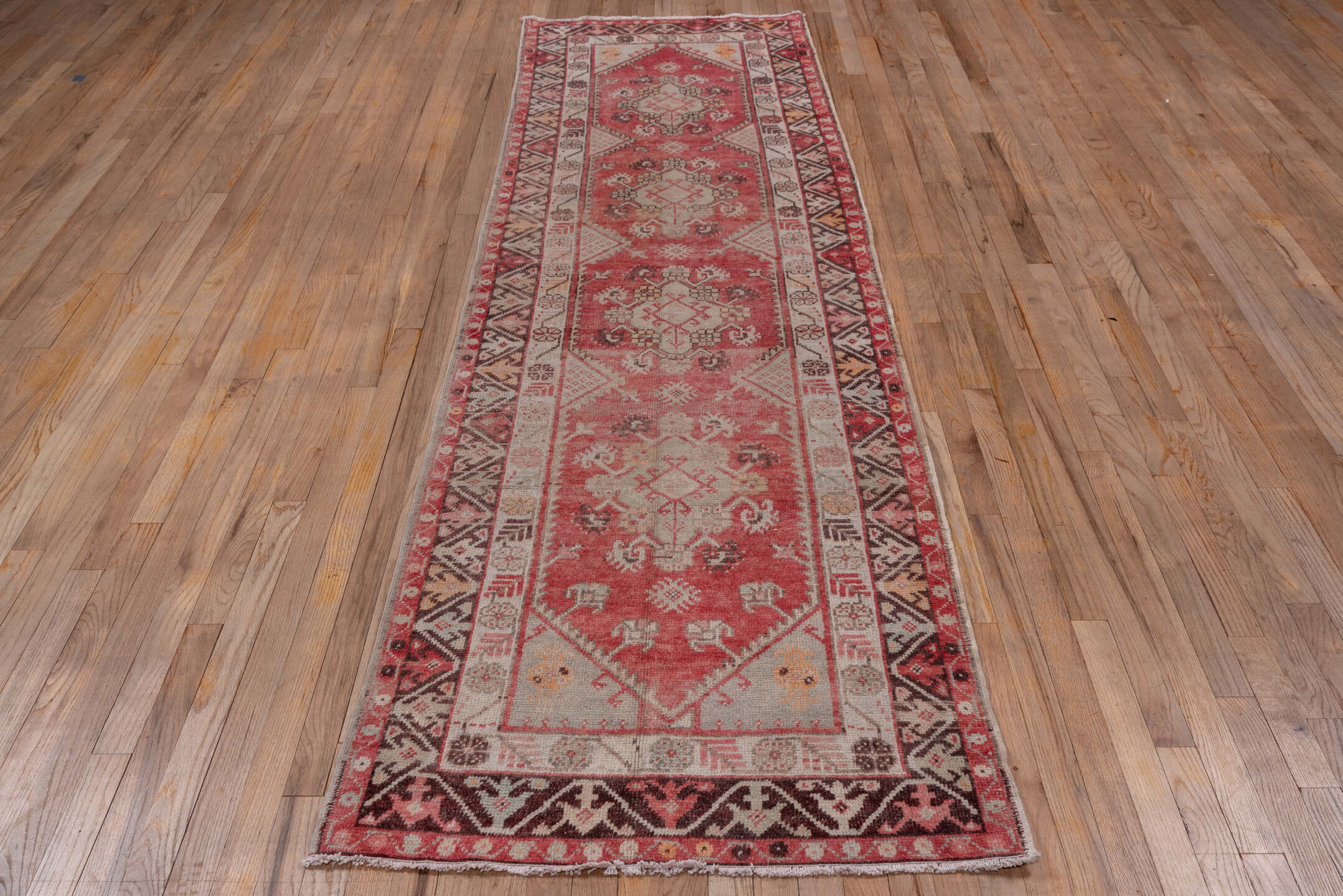 3' x 10' one-of-a-kind handmade vintage Oushak runner rug. Color palette: pink, gray, light gray, off-white, brown, red