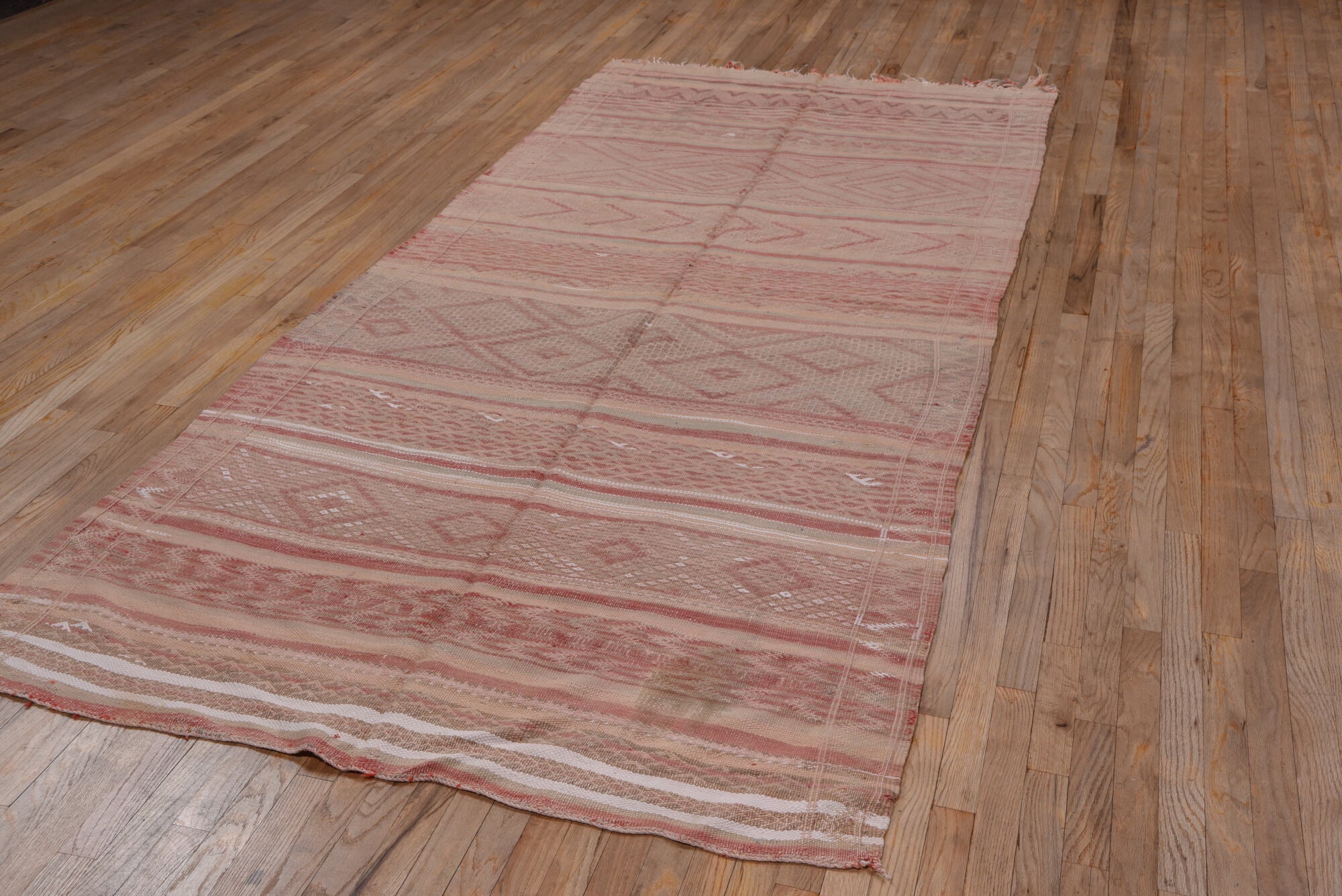 4' x 10' one-of-a-kind handmade vintage Moroccan runner rug. Color palette: brown, gray, light gray, off-white, pink, red