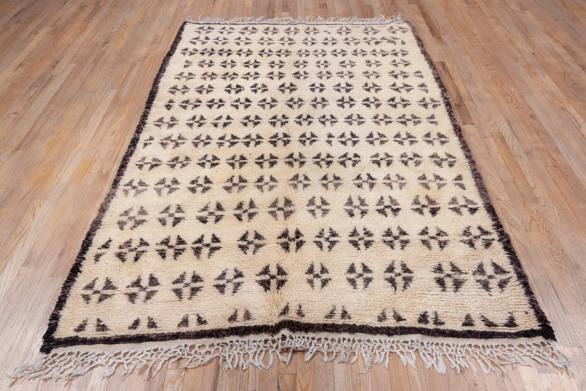 5' x 8' one-of-a-kind handmade vintage Moroccan medium size rug. Color palette: brown, gray, light gray, off-white, orange