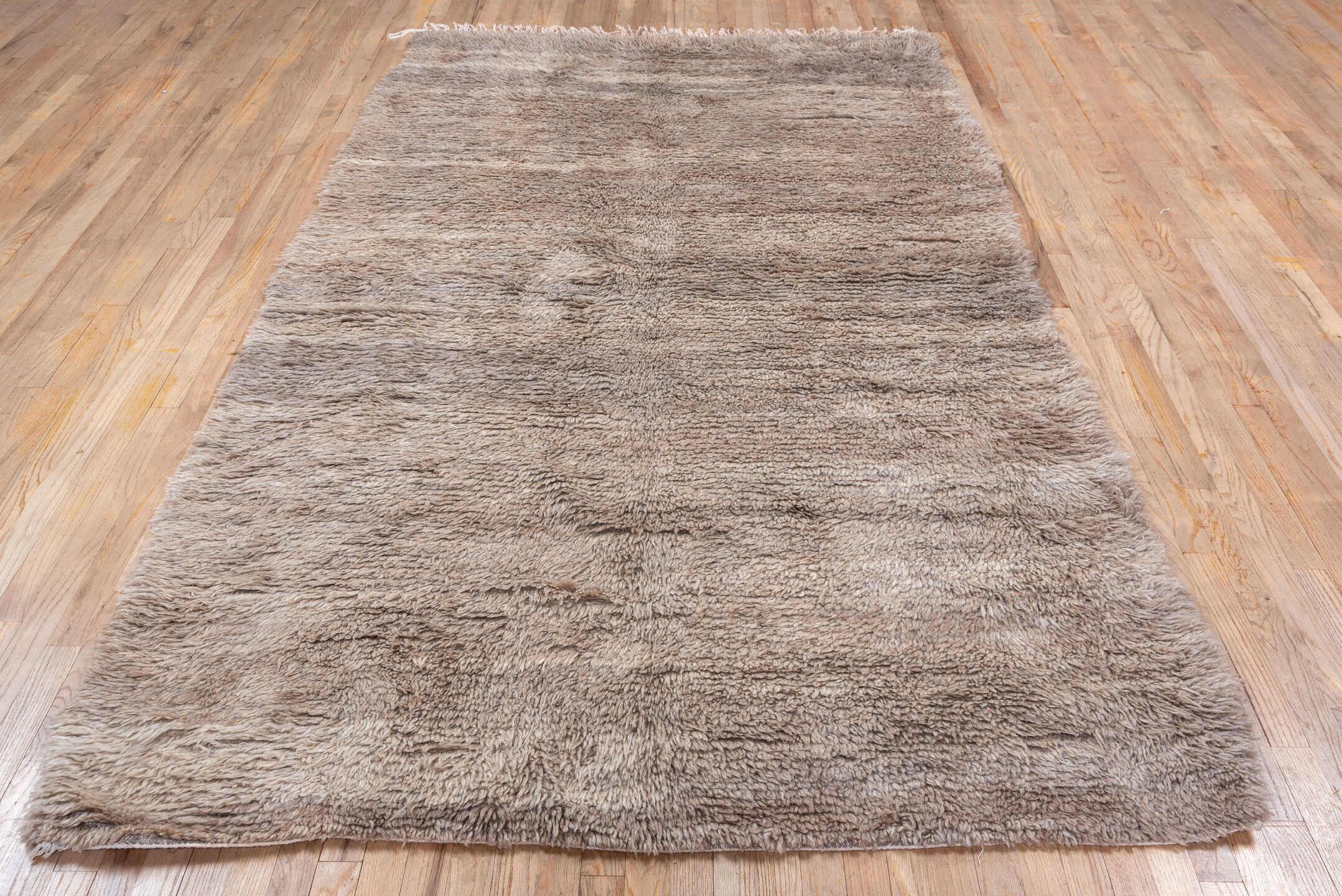 5' x 9' one-of-a-kind handmade vintage Moroccan medium size rug. Color palette: gray, pink, light gray, brown, off-white