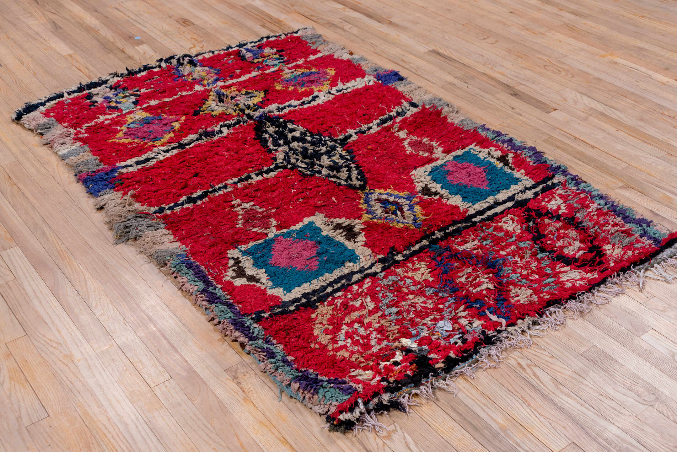 4' x 6' one-of-a-kind handmade vintage Moroccan small size rug. Color palette: brown, blue, gray, pink, red, off-white