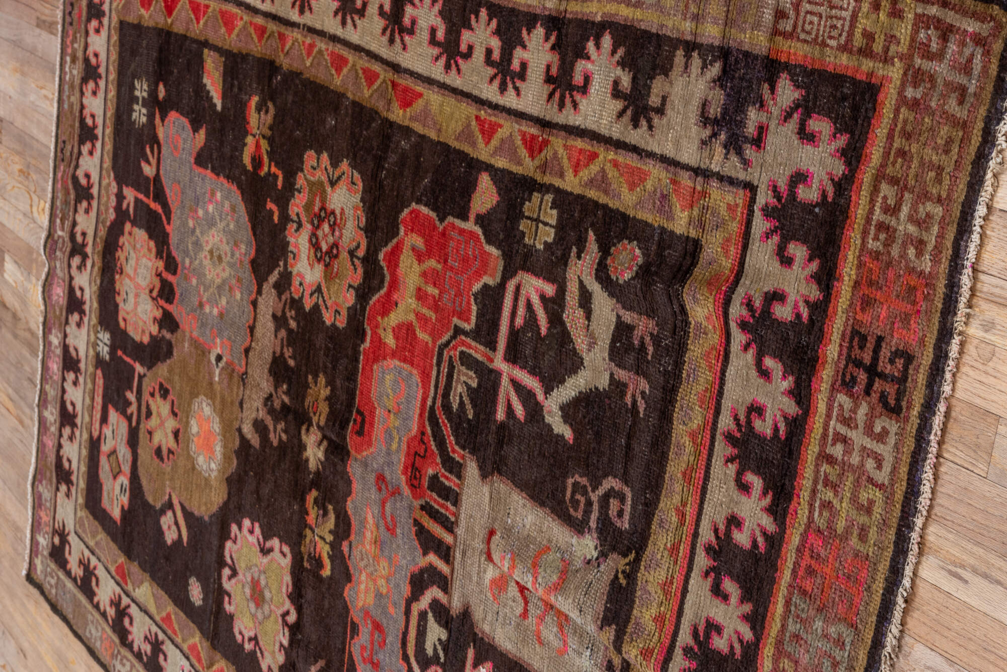 5' x 8' one-of-a-kind handmade vintage Khotan medium size rug. Color palette: black, brown, gray, pink, red