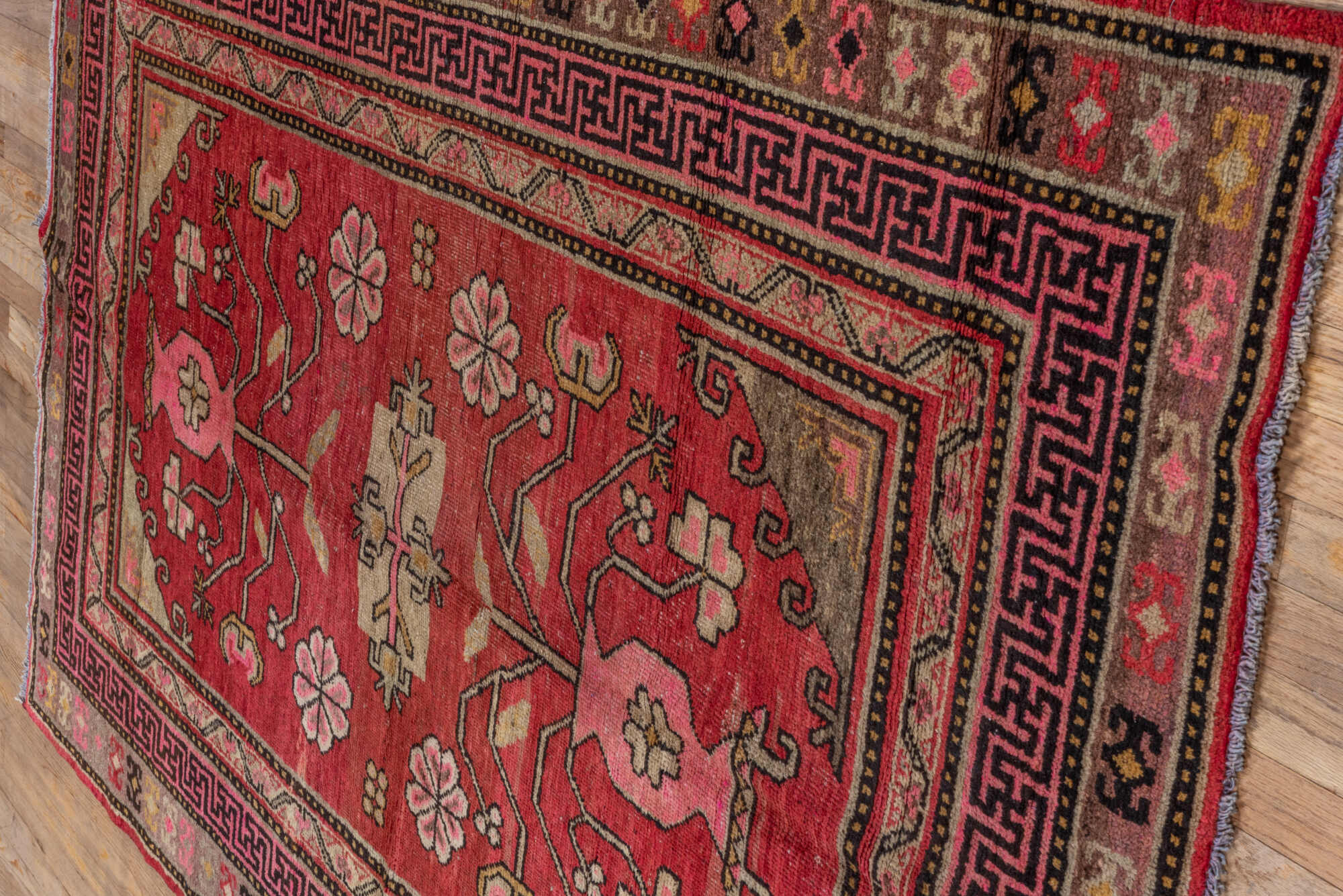 4' x 8' one-of-a-kind handmade vintage Khotan rug. Color palette: black, brown, pink, red
