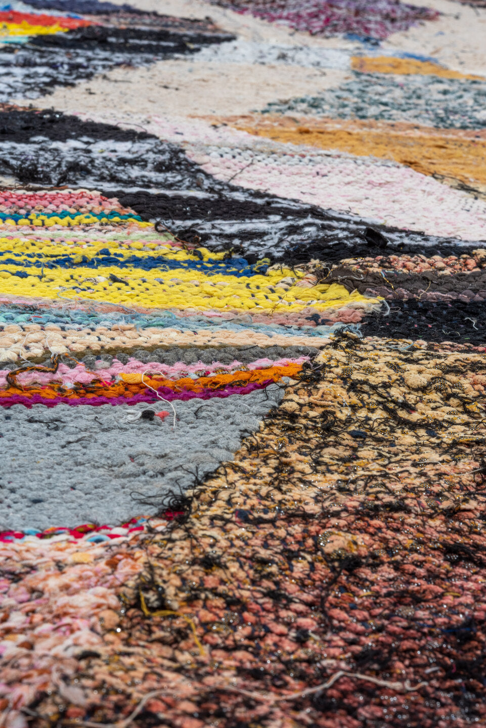 4' x 8' one-of-a-kind handmade vintage Rag Rug runner rug. Color palette: brown, gray, light gray, yellow, pink, blue, red