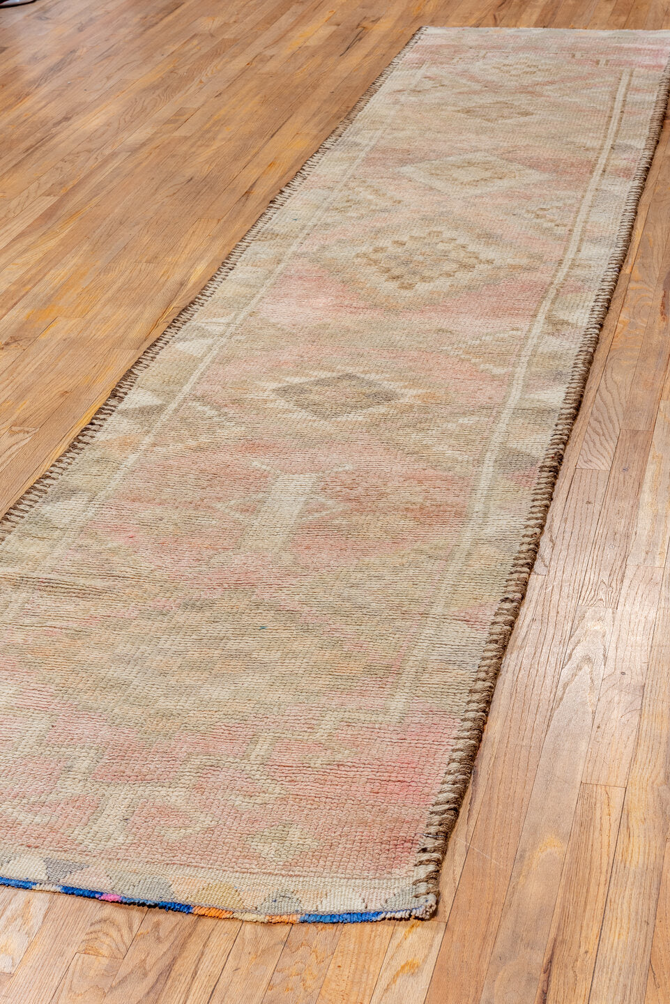 2' x 12' one-of-a-kind handmade vintage Kars runner rug. Color palette: orange, off-white, brown, pink, white, snow