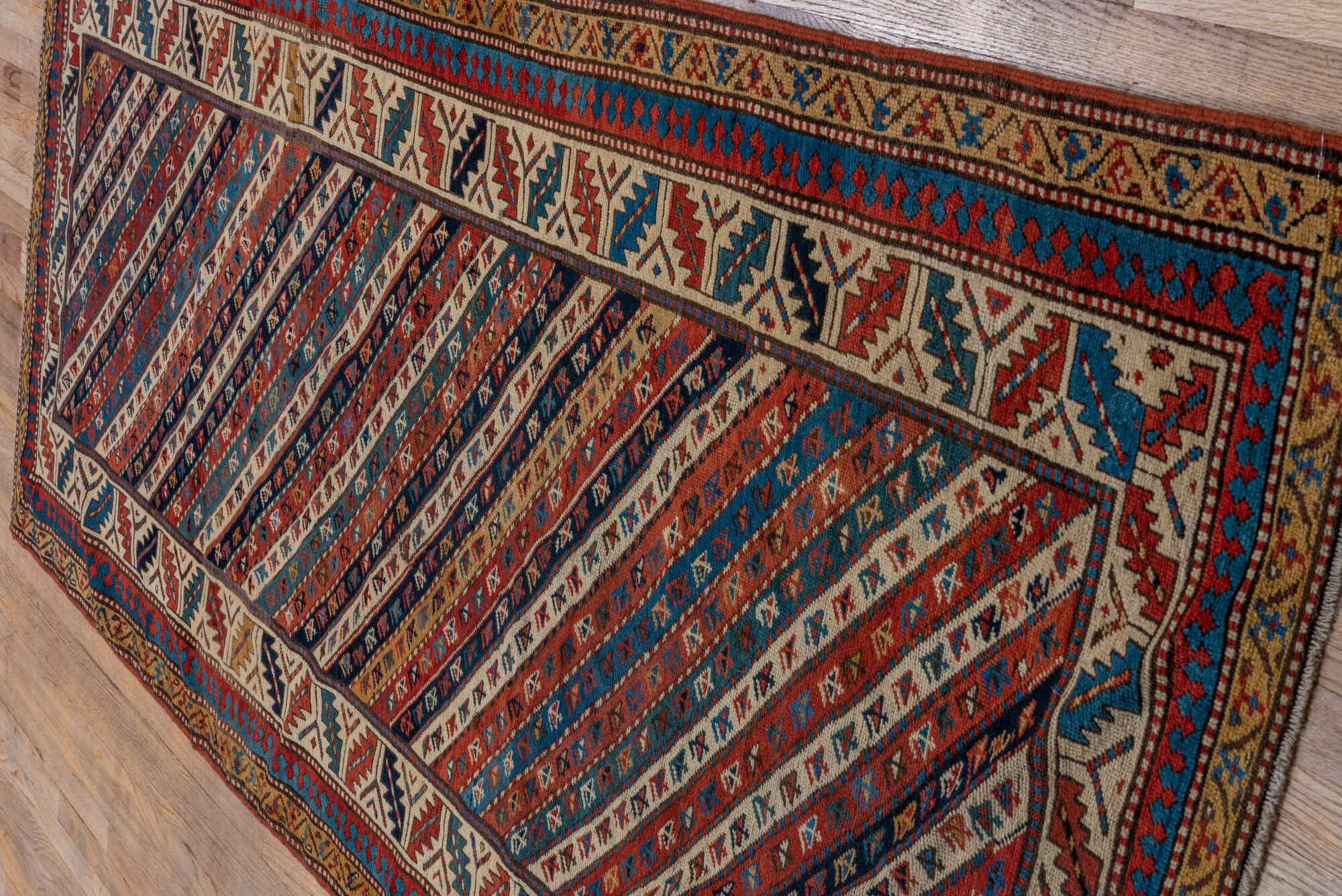 4' x 9' one-of-a-kind handmade vintage Kazak runner rug. Color palette: arapawa, black, blue, brown, gray, orange, red, tan