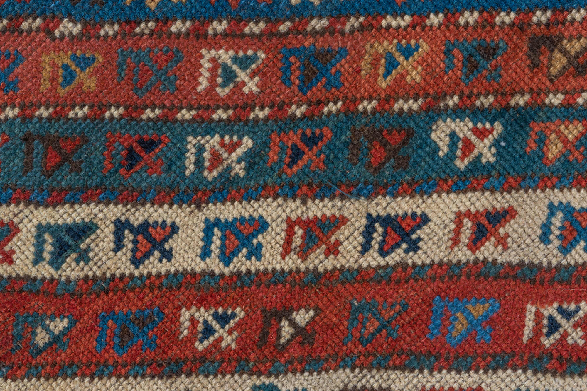 4' x 9' one-of-a-kind handmade vintage Kazak runner rug. Color palette: arapawa, black, blue, brown, gray, orange, red, tan