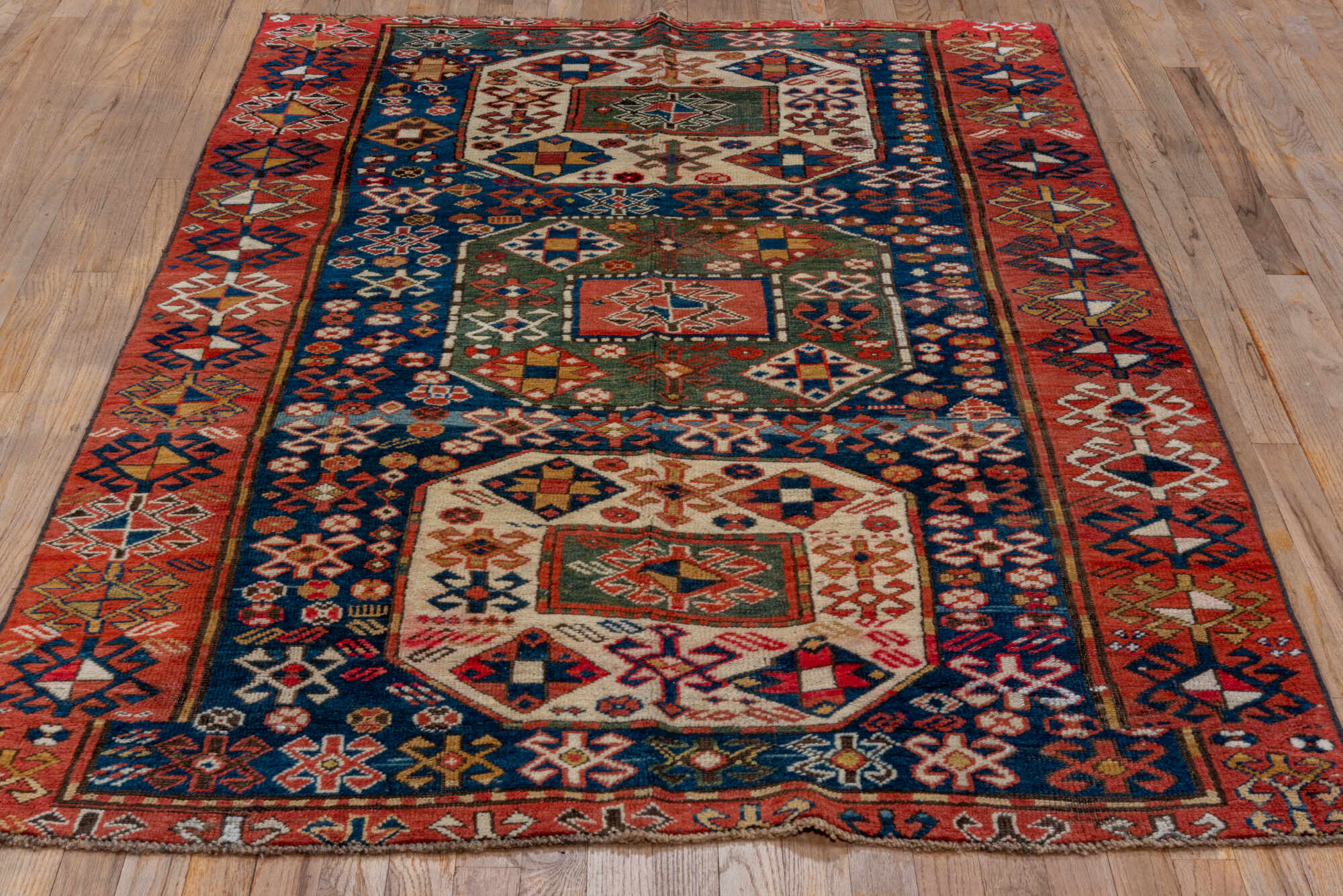 4' x 6' one-of-a-kind handmade vintage Kazak small size rug. Color palette: blue, brown, gray, pink, red