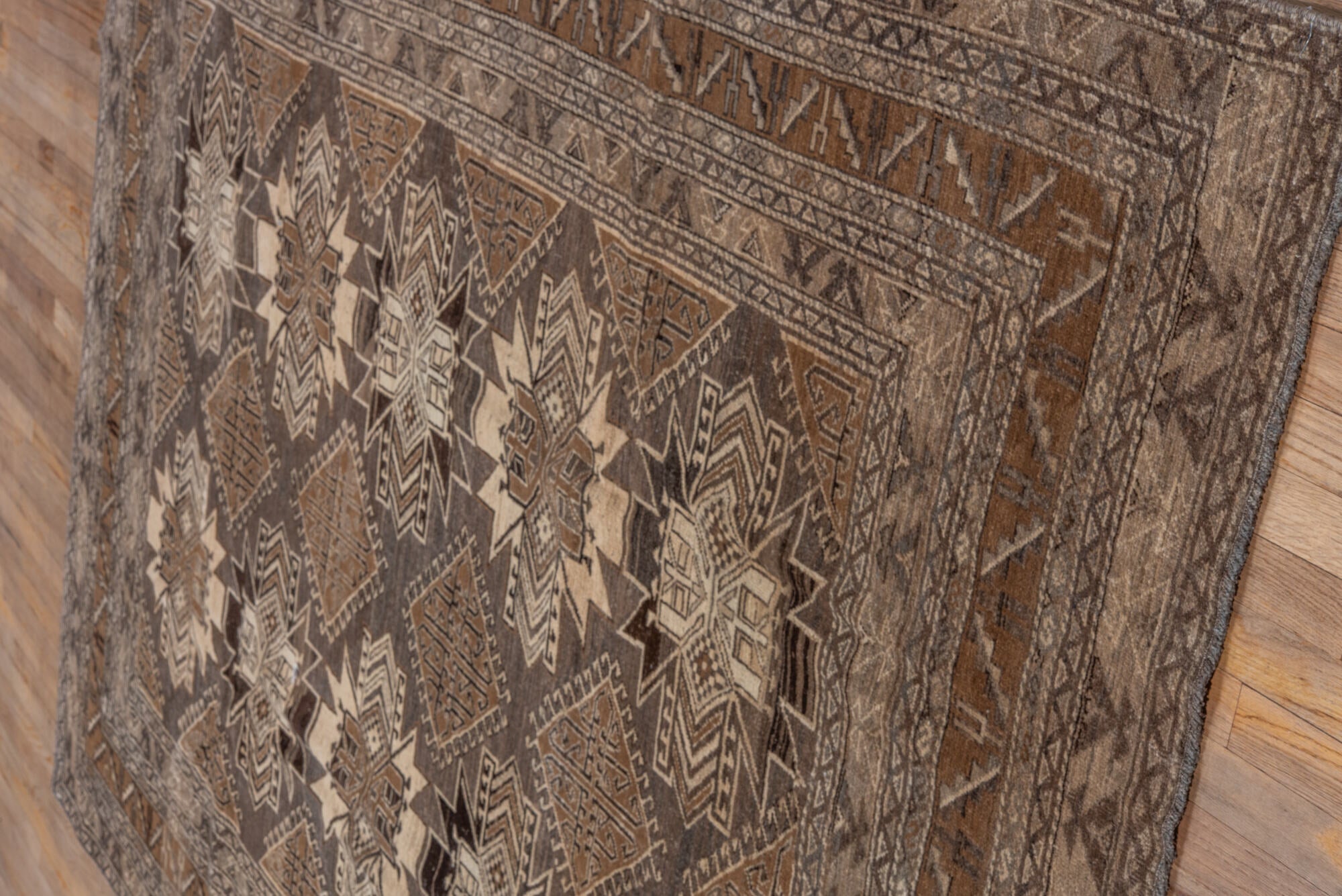 7' x 9' one-of-a-kind handmade vintage Afghan rug. Color palette: black, brown, charcoal, gray, light gray, off-white, pink