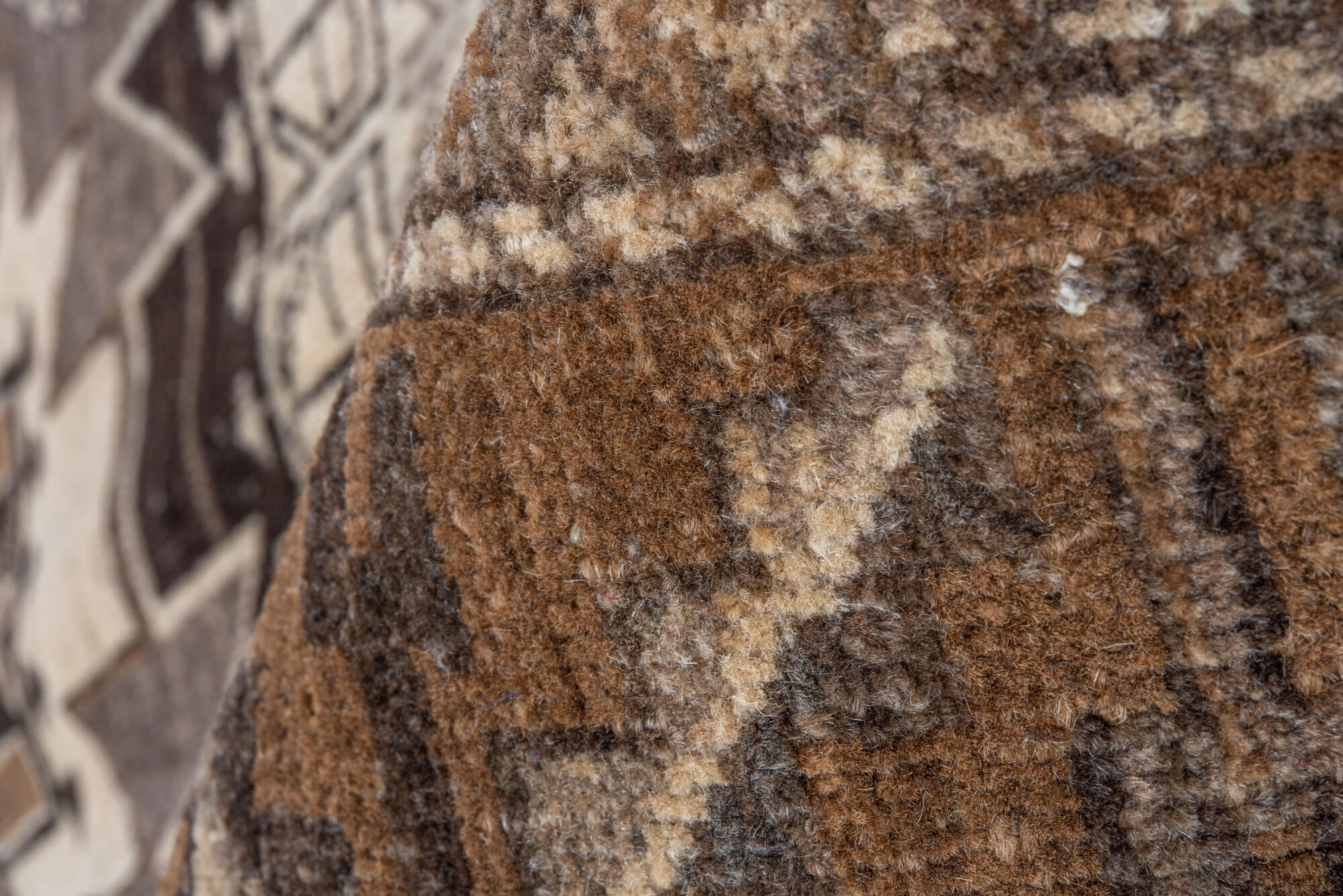 7' x 9' one-of-a-kind handmade vintage Afghan rug. Color palette: black, brown, charcoal, gray, light gray, off-white, pink